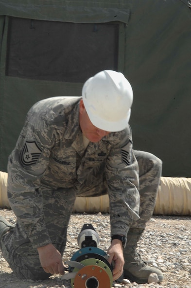 NEVADA TEST AND TRAINING RANGE, Nev.-- Master Sgt. Jan Johannes, 822nd Base Defense Squadron communication division chief from Moody Air Force Base, Ga., takes apart equipment March 16, 2011, after the end of DESERT EAGLE. For this British and American joint-force exercise, the 822nd BDS communication division brought 18,000 pounds of equipment to support the Airmen, including handheld radios and antennae. (U.S. Air Force photo/Airman 1st Class Brigitte N. Brantley-Sisk)(RELEASED)