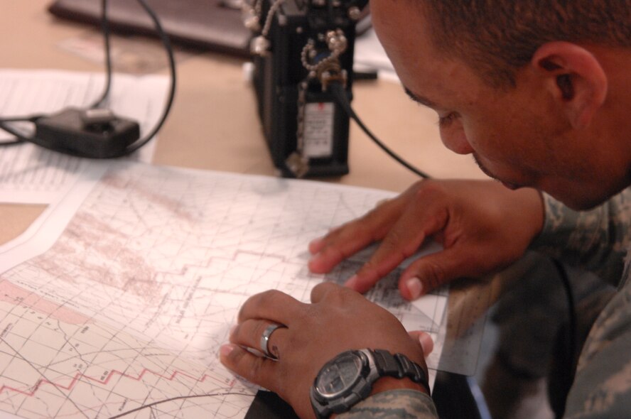 NEVADA TEST AND TRAINING RANGE, Nev.-- 1st Lt. Ralph Johnson, 822nd Base Defense Squadron battle commander from Moody Air Force Base, Ga., analyzes intelligence March 15, 2011, during DESERT EAGLE. Intelligence and communication were the key components behind making sure the American and British Airmen were able to complete the mission. (U.S. Air Force photo/Airman 1st Class Brigitte N. Brantley-Sisk)(RELEASED)