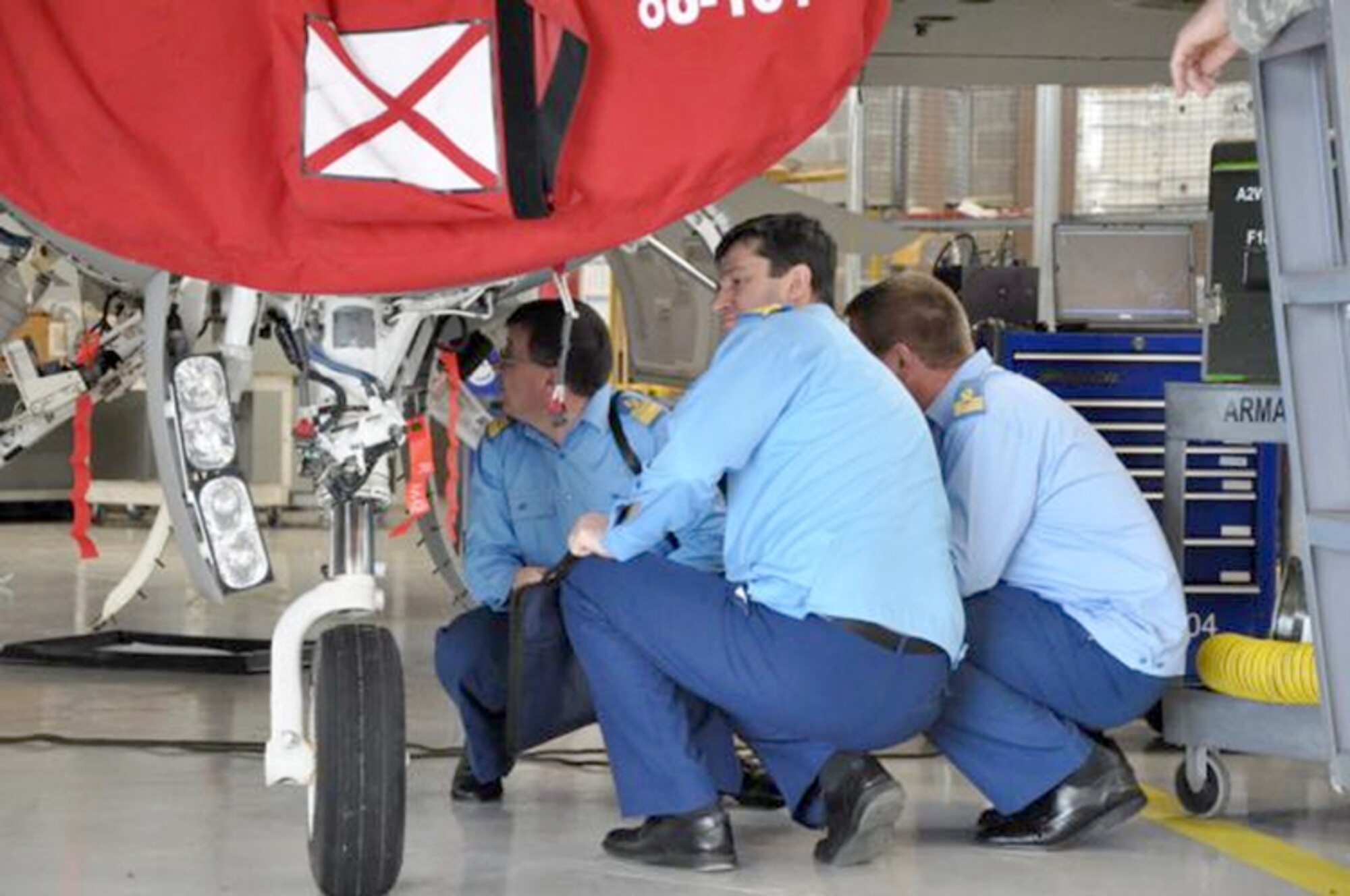 Romanian air force officers look over an F-16 Fighting Falcon at the Alabama National Guard's 187th Fighter Wing during a recent visit as part of the National Guard's state partnership program. (Courtesy photo)