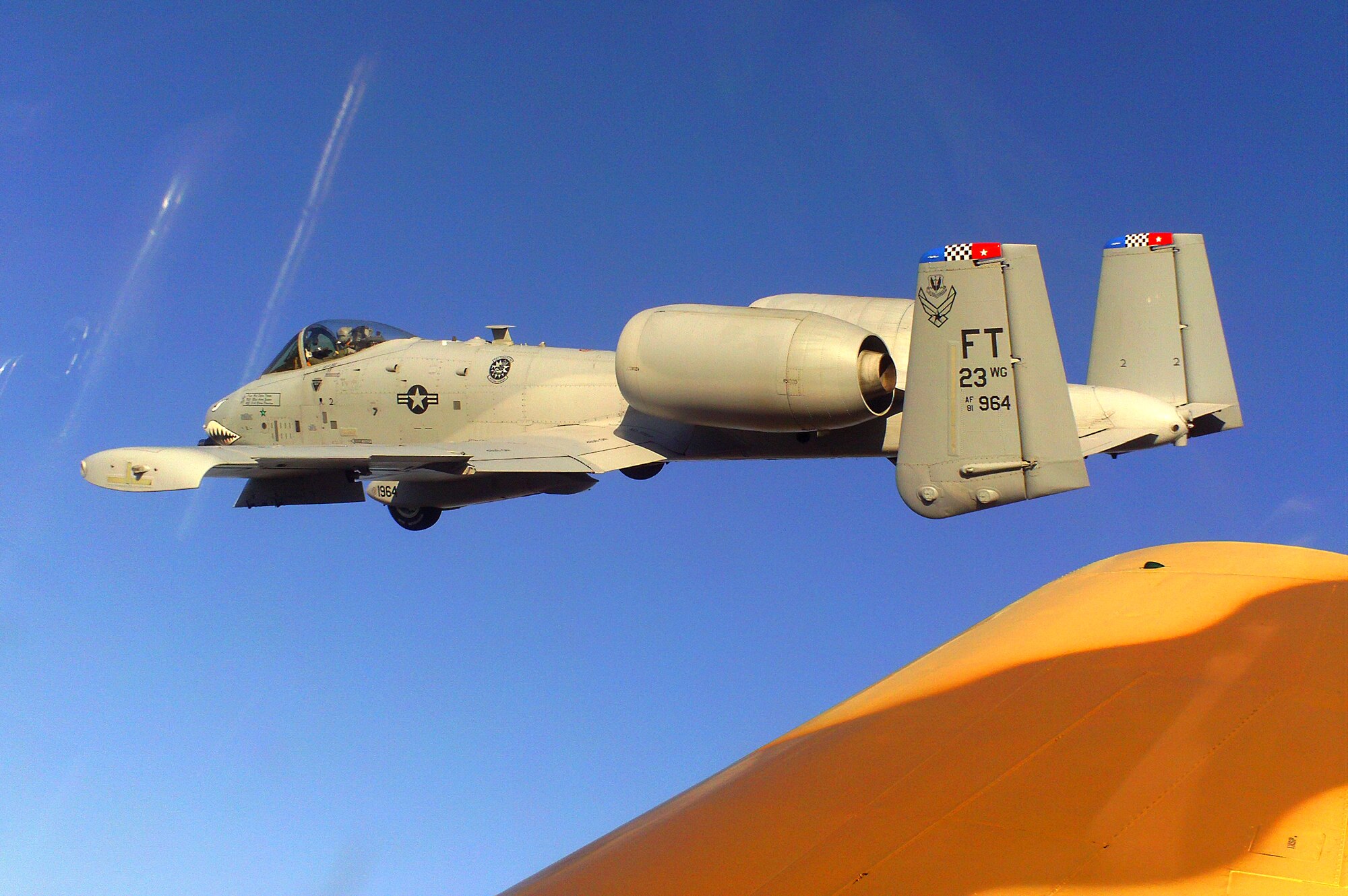 DAVIS-MONTHAN, Ariz.-- An A-10C Thunderbolt II aircraft flies next to a Curtiss P-40 Warhawk at the 2011 Air Combat Command Heritage Flight Conference March 12. (Contributed photo) (RELEASED)