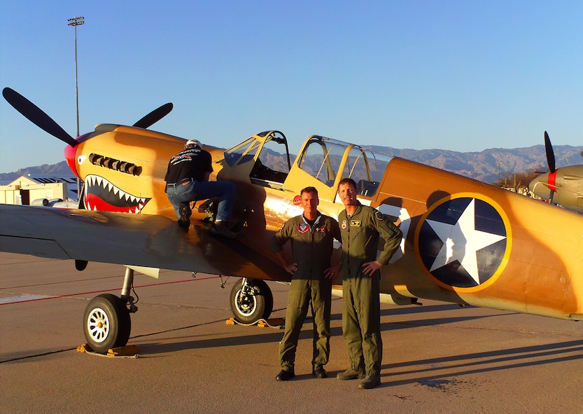 DAVIS-MONTHAN AIR FORCE BASE, Ariz.-- Col. Gary Henderson, 23rd Wing commander,  and Kevin Eldridge, P-40 demonstration pilot, stand in front of a Curtiss P-40 Warhawk at the 2011 Air Combat Command Heritage Flight Conference March 12. (Contributed photo) (RELEASED)