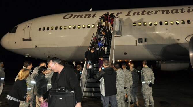 Passengers of a DC-10 military-chartered flight arriving from Japan de-board on the Travis Air Force Base, Calif., flightline March 22, 2011, at approximately 6 a.m. Service members, family members and civil service employees voluntarily left Japan in efforts to assist and expedite recovery efforts in the country by reducing the demand for food, water, fuel and electricity during this national emergency while hundreds of thousands of Japanese citizens remain displaced. (U.S. Air Force Photo/Airman 1st Class Michael Battles)