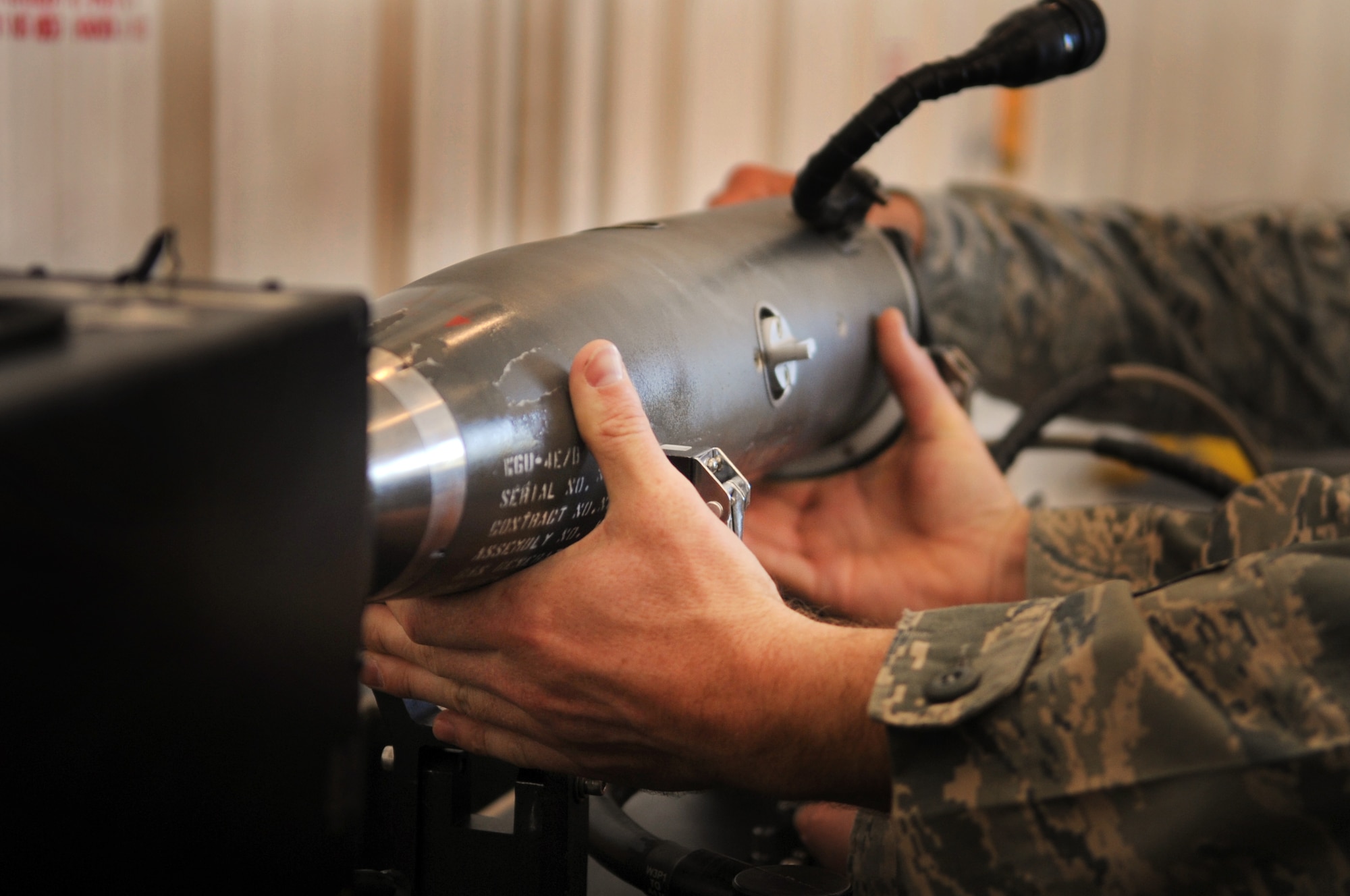 MOODY AIR FORCE BASE, Ga. -- Tech. Sgt. David Edwards, 23rd Equipment Maintenance Squadron precision guided munitions production supervisor, places an AIM-9 Sidewinder air-to-air missile onto a guidance control section test set March 22. The guidance control section test set will conduct a 25-minute functional check of the AIM-9. (U.S. Air Force photo/Airman 1st Class Douglas Ellis)(RELEASED)
