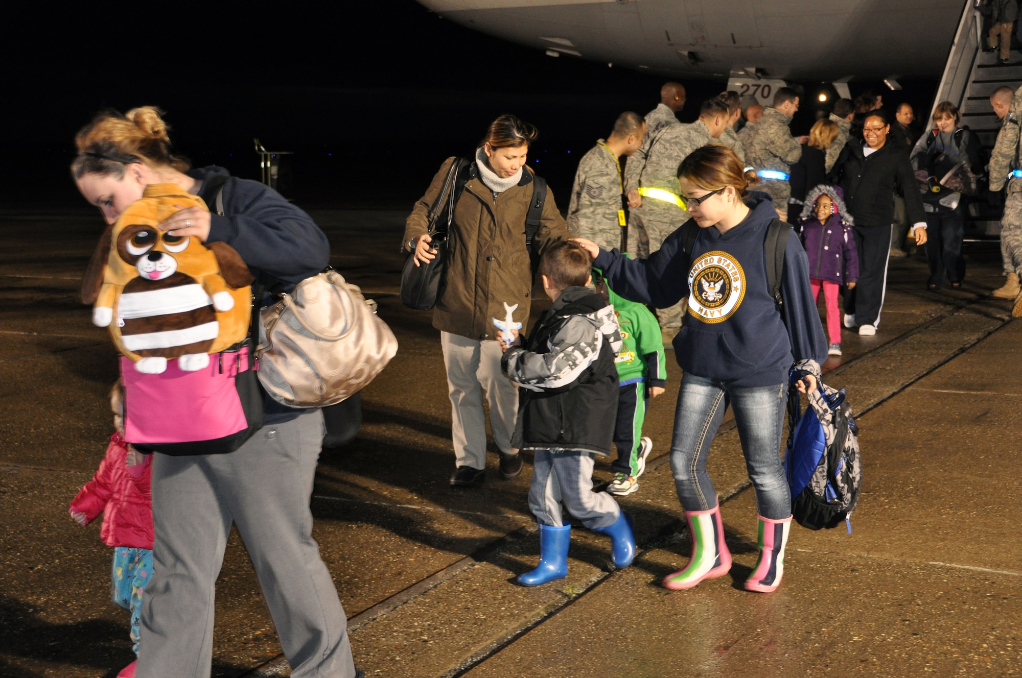 Passengers of the DC-10 military chartered flight de-boarded on the Travis Air Force flight line March 22 at approximately 6 a.m. Service members, dependants and civil service employees voluntarily left Japan in efforts to assist and expedite recovery efforts in Japan by reducing the demand for food, water, fuel and electricity during this national emergency while hundreds of thousands of Japanese citizens remain displaced. (U.S. Air Force photos/Airman 1st Class Michael Battles)
