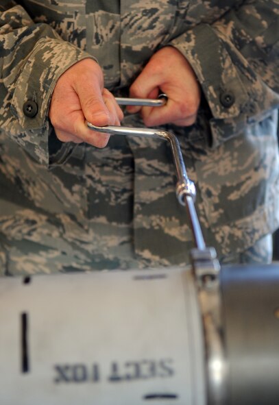 MOODY AIR FORCE BASE, Ga. -- Tech. Sgt. David Edwards, 23rd Equipment Maintenance Squadron precision guided munitions production supervisor, removes a screw from an AIM-9 Sidewinder air-to-air missile March 22. The precision guided munitions flight ensured the AIM-9 missile was fully functional. (U.S. Air Force photo/Airman 1st Class Douglas Ellis)(RELEASED)
