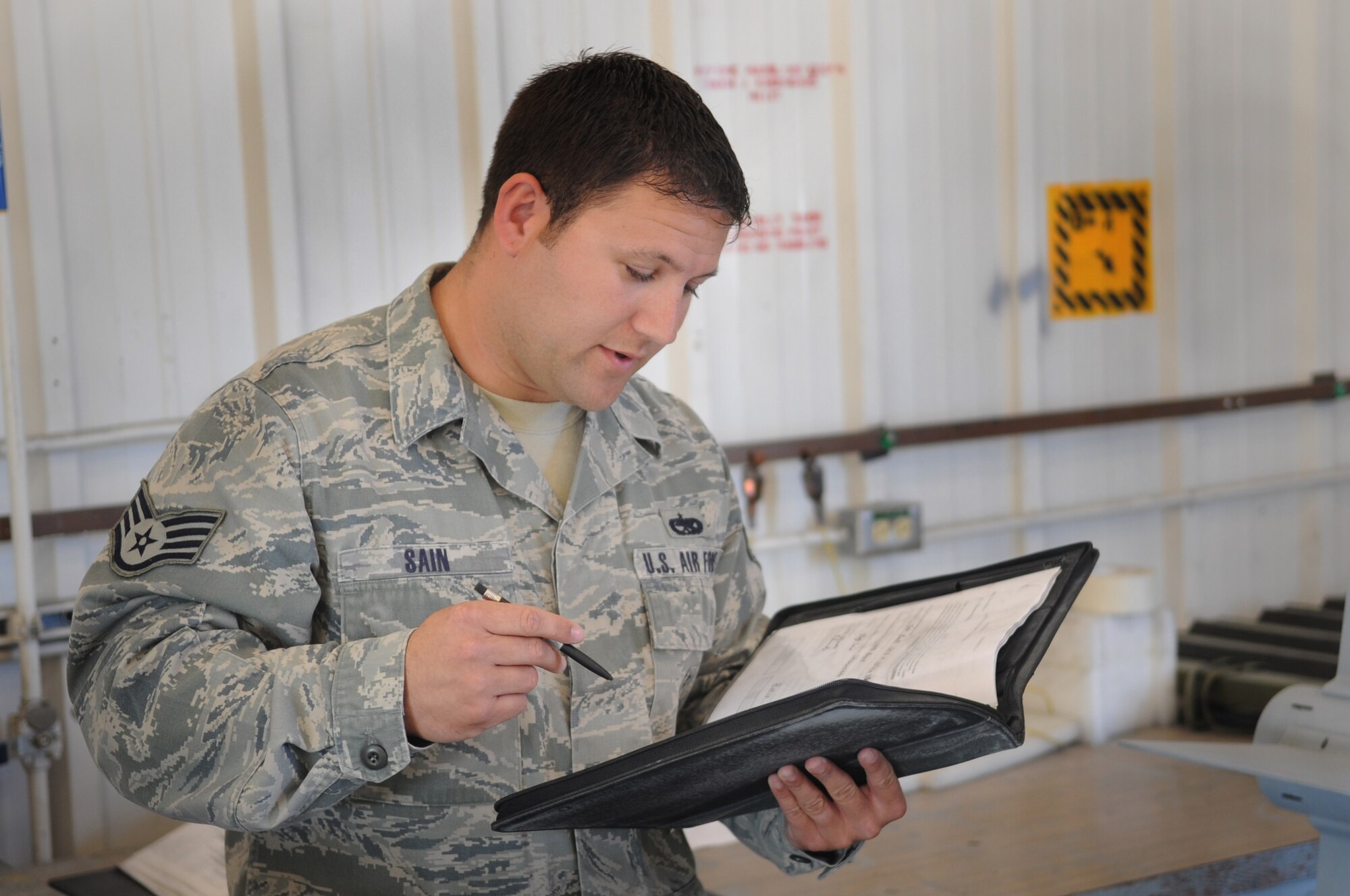 MOODY AIR FORCE BASE, Ga. -- Staff Sgt. David Sain, 23rd Equipment Maintenance Squadron precision guided munitions crewchief, gives a brief on safety precautions before working on an AIM-9 Sidewinder air-to-air missile March 22. The precision guided munitions flight performed a functional check on the AIM-9. (U.S. Air Force photo/Airman 1st Class Douglas Ellis)(RELEASED)
