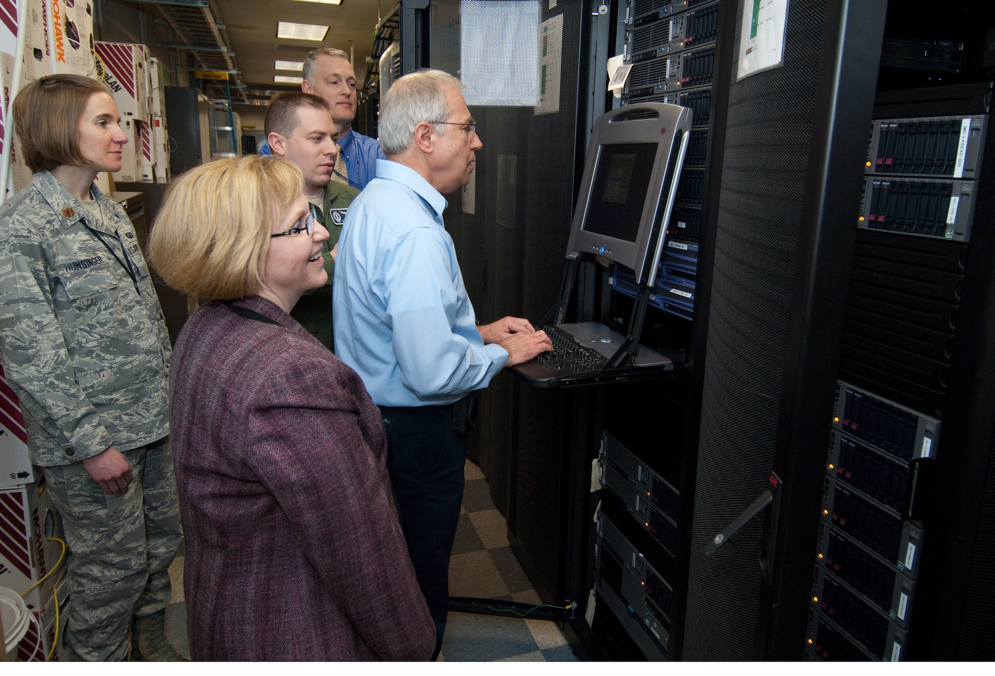 The AFNet Increment 1 team reviews Integrated Management Site Equipment at the Hanscom AFB Lab March 22.  Looking on (l to r) are: Maj. Stephani Hunsinger, Linda Mann, Capt. Michael Crowl, Vince Ross and Jan Krajewski and.  (USAF Photo by Rick Berry)