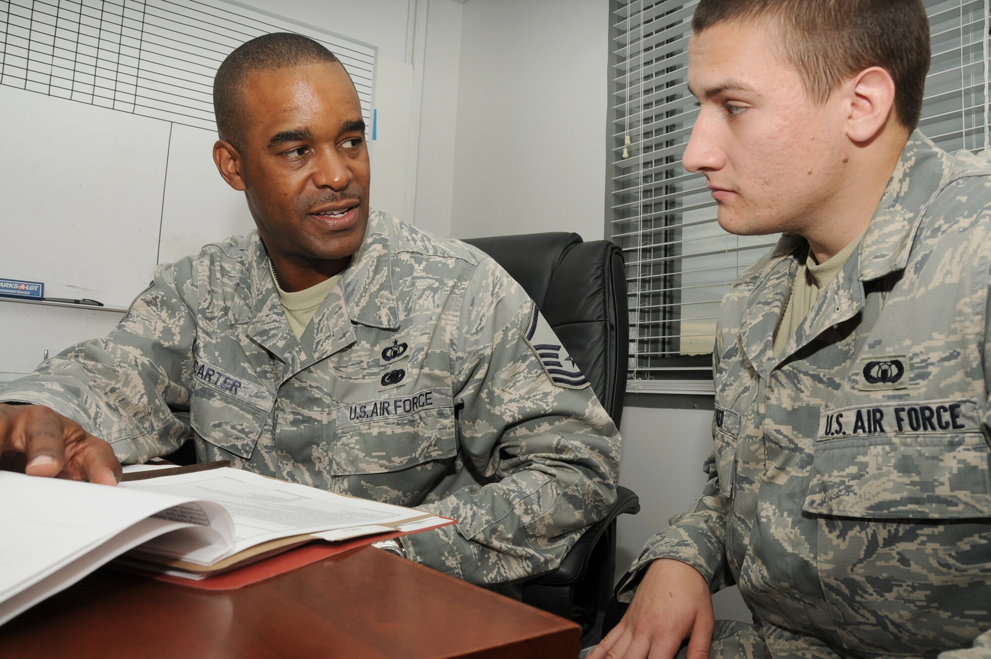 Sergeant Carter, left, reviews Senior Airman Cody Baker’s deployment folder March 9.
Airman Baker, 81st OSF, is deploying to Al-Udeid Air Base, Qatar.  (U.S. Air Force photo by Kemberly Groue)