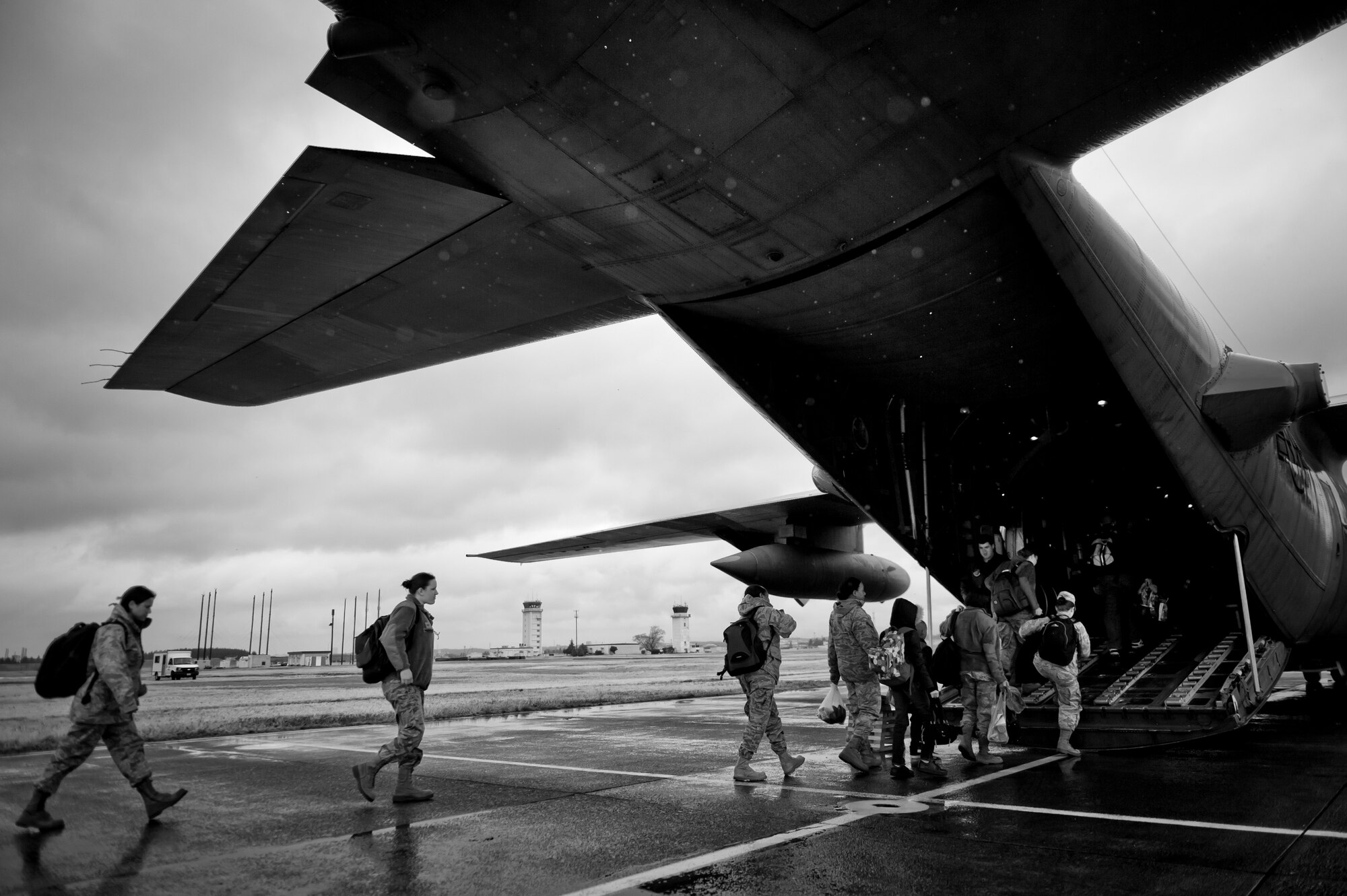 YOKOTA AIR BASE, Japan -- Current and expectant military mothers and their children board a C-130H Hercules here, bound for Kadena Air Base, Japan, March 22. Expectant mothers with fewer than 34 weeks of pregnancy were allowed to depart mainland Japan, so heavily tasked medical staff can focus on those affected by the earthquake and tsunami. (U.S. Air Force photo/Staff Sgt. Samuel Morse)