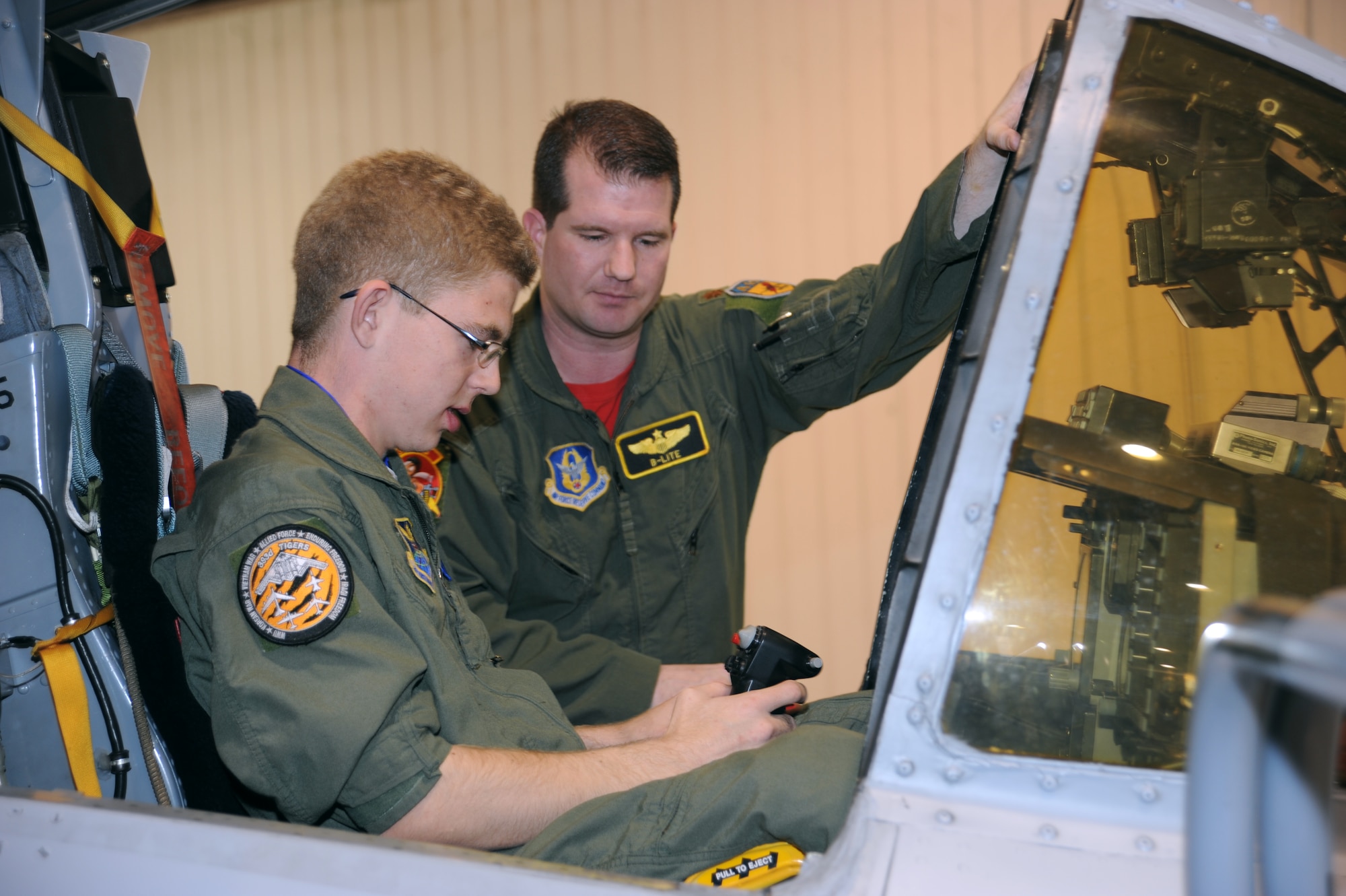 Andrew Swan sits in the cockpit of an A-10 Thunderbolt II, as  Major Brian Leiter, 303rd Fighter Squadron chief of scheduling and A-10 pilot, explains the controls, March 19. Andrew visited Whiteman Air Force Base to be an Airman for a day as part of a Dream Factory project. (U.S. Air Force photo by Staff Sgt Lauren Padden)(Released)


