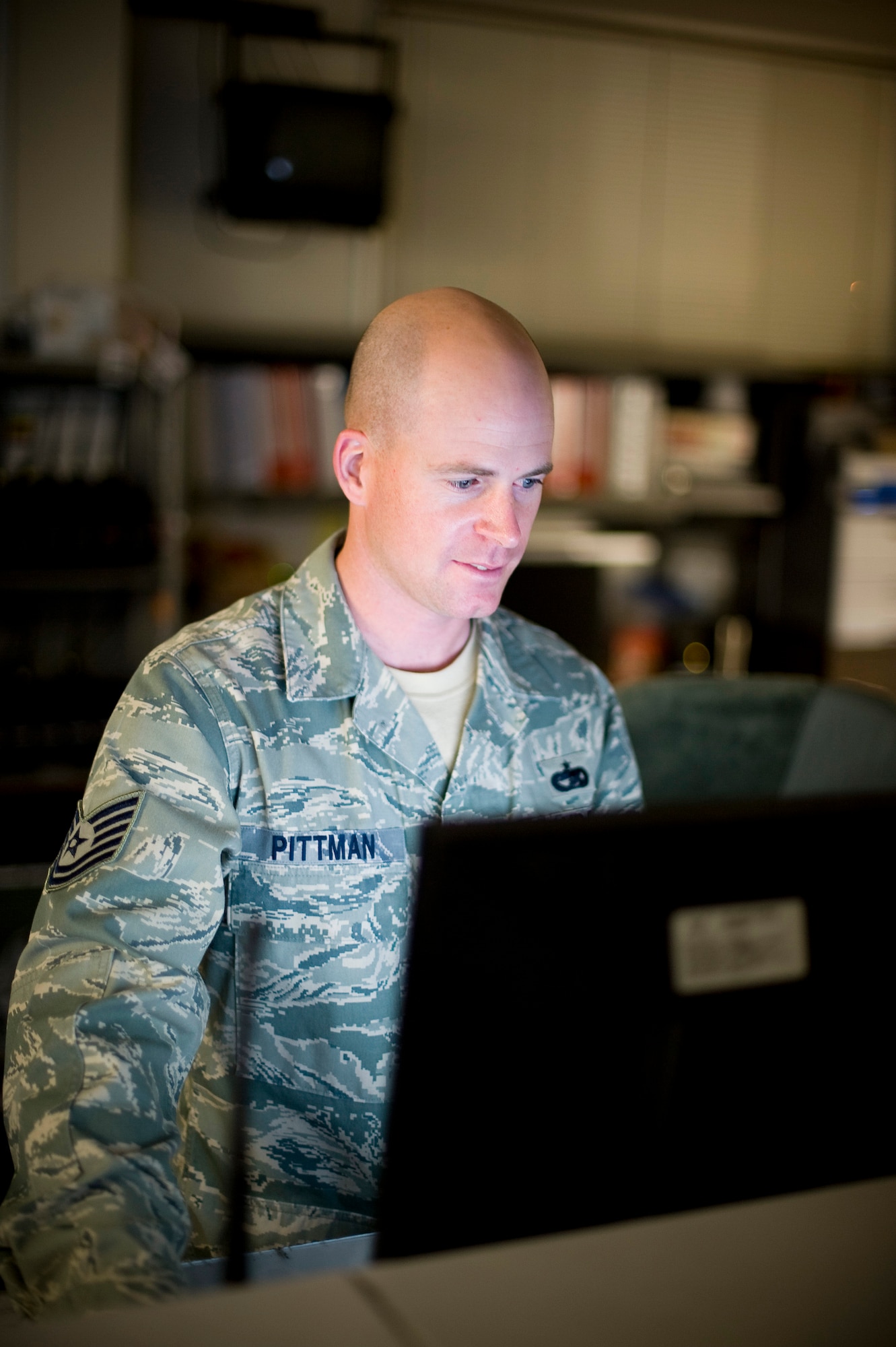 YOKOTA AIR BASE, Japan -- Tech. Sgt. Justin Pittman, 374th Logistics Readiness Squadron vehicle dispatch operator, monitors vehicle operations on his computer here March 23. In the last two weeks, LRS has tripled their efforts, to include shuttle bus operations and issuing government vehicles to units that have acquired additional personnel in part of the relief effort. (U.S. Air Force photo/Staff Sgt. Chad Strohmeyer)