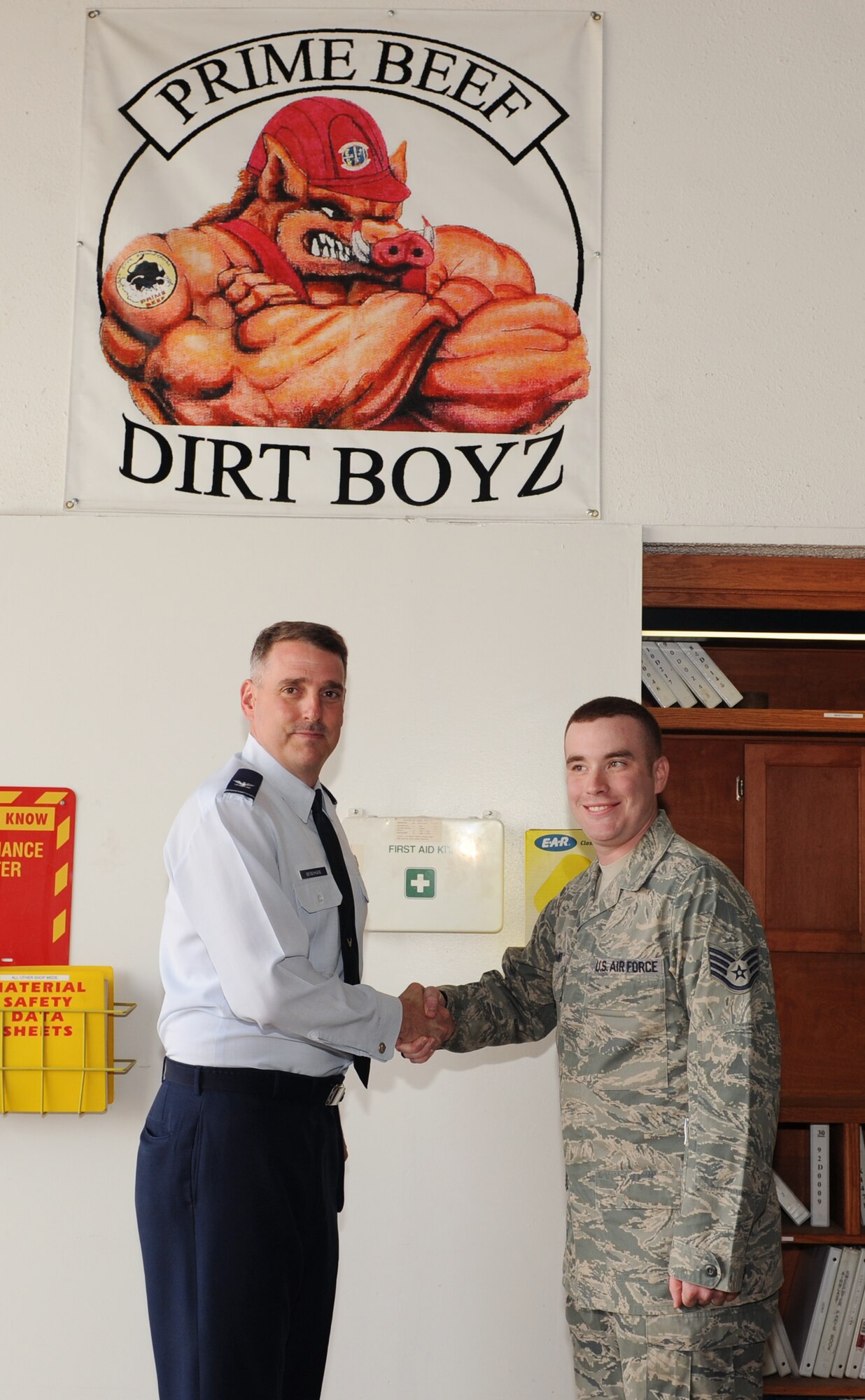 Col. Mike Minihan, the 19th Airlift Wing commander, presents a coin to Staff Sgt.  Stephen Bryant, a 19th Civil Engineer Squadron pavement and equipment craftsman, at Little Rock Air Force Base, Ark., March 21, 2011. Sergeant Bryant eliminated spalls on flightline parking addressing foreign object debris concerns.  (Air Force photo by Airman 1st Class Ellora Stewart)