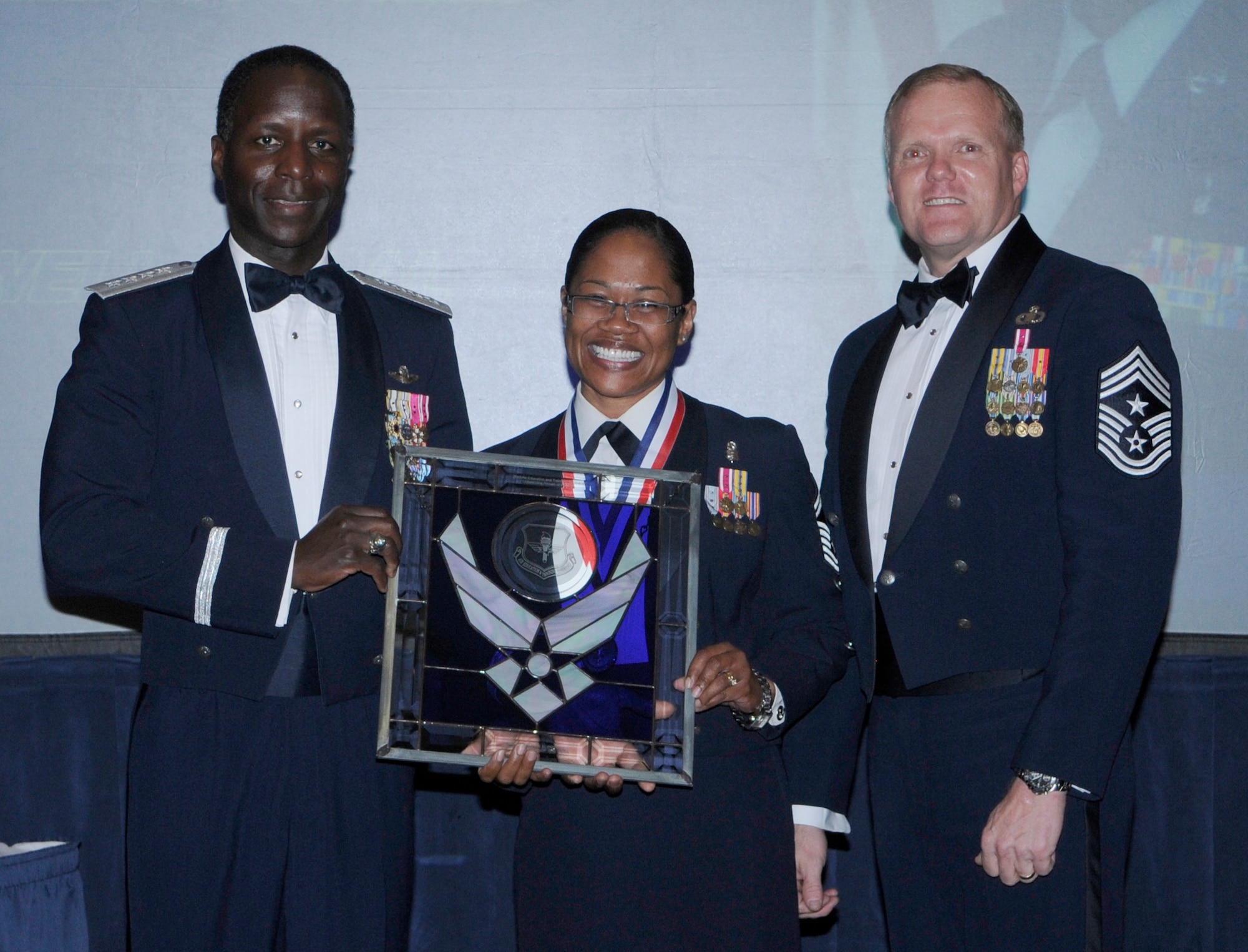 General Edward Rice, Air Education And Training Command commander and Chief Master Sergeant James Cody, Air Education and Training Command , command chief presents award to SMSgt Mauree C. Powell, from Air University, Maxwell Air Force Base Alabama, as First Sergeant Of The Year.  Ceremony was held at the Parr Officer Club at Randolph Air Force Base, Texas on March 18.(U.S. Air Force photo/by Don Lindsey).