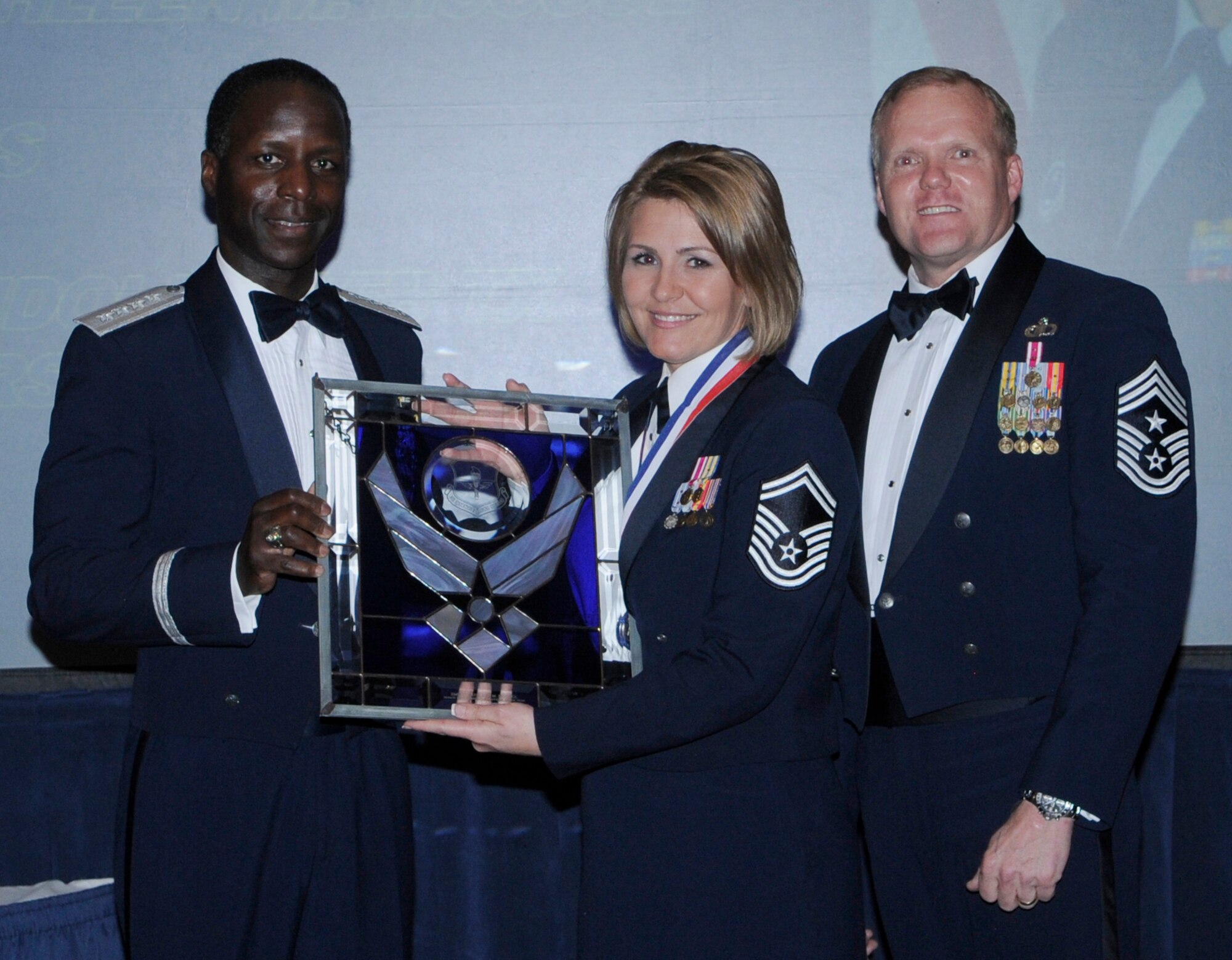 General Edward Rice, Air Education And Training Command commander and Chief Master Sergeant James Cody, Air Education and Training Command , command chief presents award to Senior Master Sergeant Kathleen M. Cool, Air Force Recruiting Service, Randolph Air Force Base Texas, Senior Noncommissioned Officer of the Year.  Ceremony was held at the Parr Officer Club at Randolph Air Force Base, Texas on March 18.(U.S. Air Force photo/by Don Lindsey).