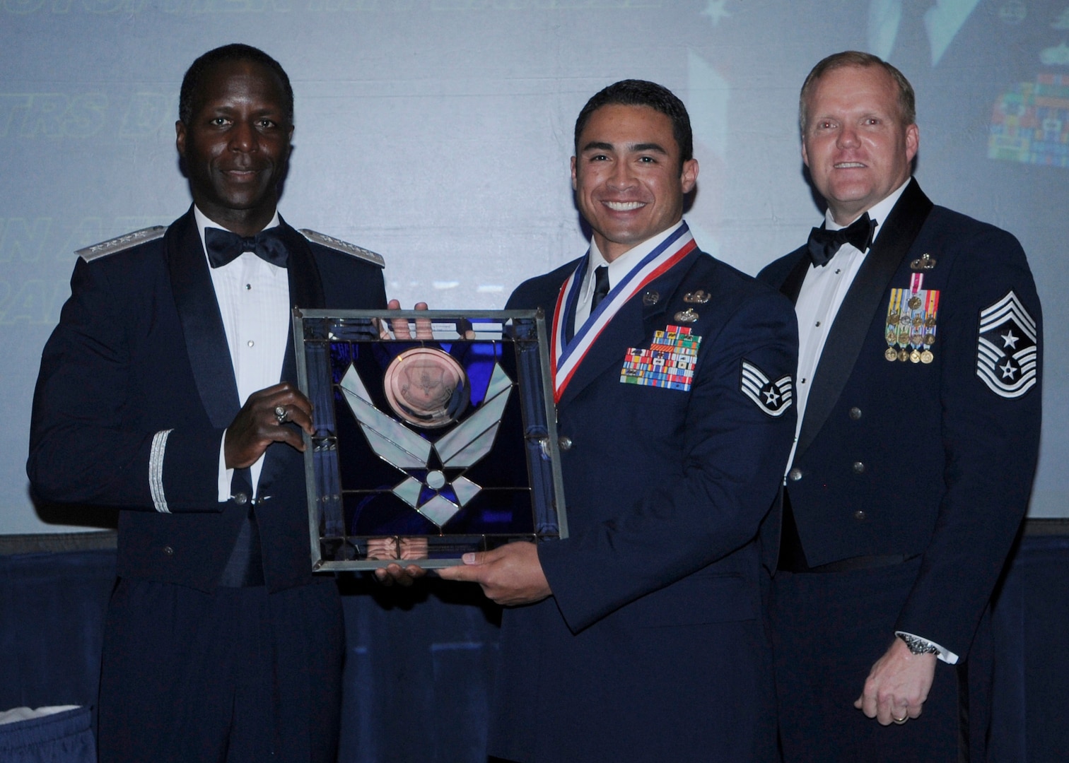 General Edward Rice, Air Education And Training Command commander and Chief Master Sergeant James Cody, Air Education and Training Command , command chief presents Noncommissioned Officer Of The Year award to Staff Sergeant Christopher M. Ferrell, 336 TRS Det. 3, Eglin AFB, Florida.  Ceremony was held at the Parr Officer Club at Randolph Air Force Base, Texas on March 18.(U.S. Air Force photo/by Don Lindsey).
