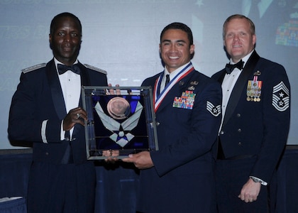 General Edward Rice, Air Education And Training Command commander and Chief Master Sergeant James Cody, Air Education and Training Command , command chief presents Noncommissioned Officer Of The Year award to Staff Sergeant Christopher M. Ferrell, 336 TRS Det. 3, Eglin AFB, Florida.  Ceremony was held at the Parr Officer Club at Randolph Air Force Base, Texas on March 18.(U.S. Air Force photo/by Don Lindsey).