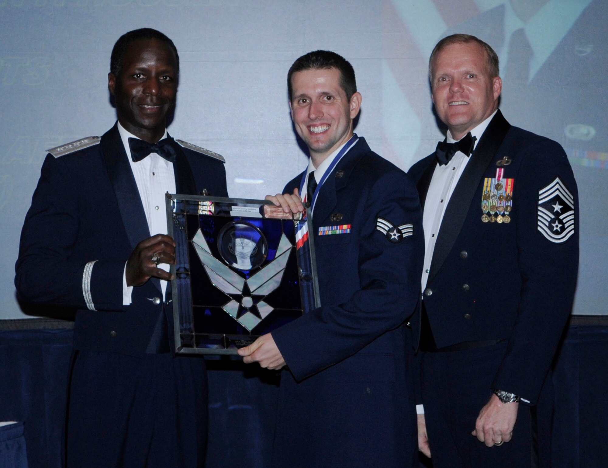 General Edward Rice, Air Education And Training Command commander and Chief Master Sergeant James Cody, Air Education and Training Command , command chief presents Airmen Of The Year award to Senior Airmen Shaun P. Houser, 56 CPTS, Luke Air Force Base Arizona.  Ceremony was held at the Parr Officer Club at Randolph Air Force Base, Texas on March 18.(U.S. Air Force photo/by Don Lindsey).