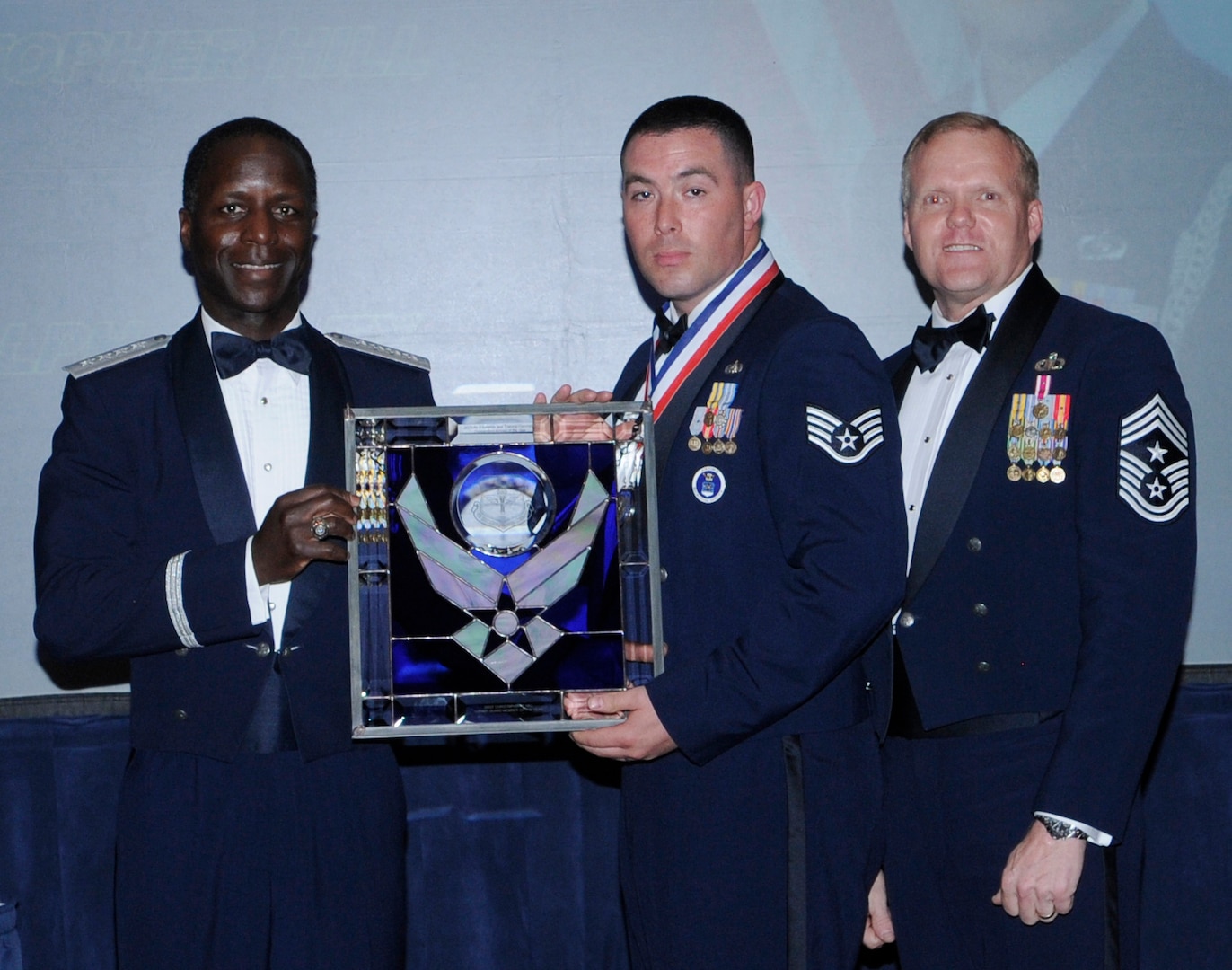 General Edward Rice, Air Education And Training Command commander and Chief Master Sergeant James Cody, Air Education and Training Command , command chief presents Honor Guard Of The Year Member award to Staff Sergeant Christopher hill, Air Force recruiting Service, Randolph Air Force Base, Texas.  Ceremony was held at the Parr Officer Club at Randolph Air Force Base, Texas on March 18.(U.S. Air Force photo/by Don Lindsey).