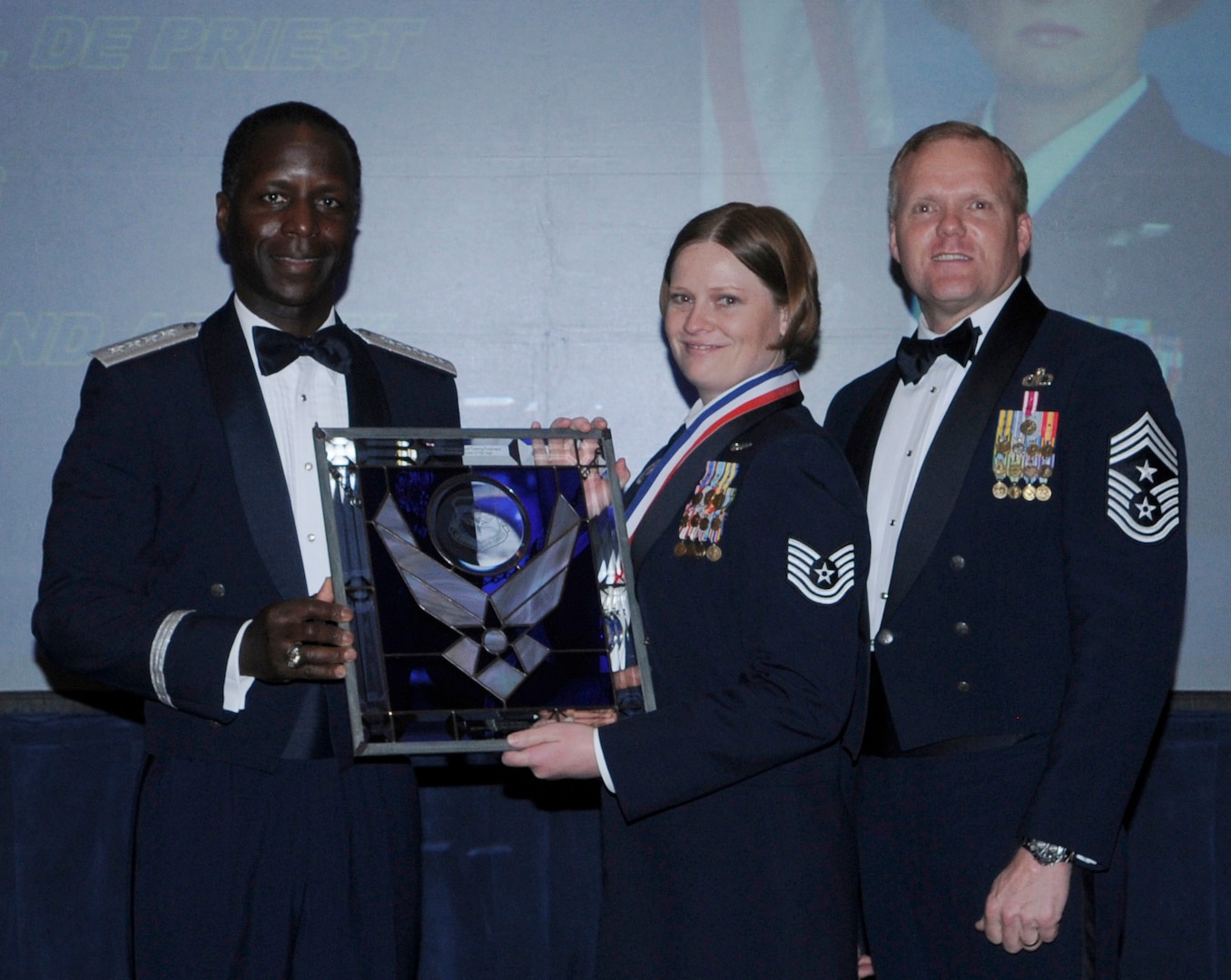 General Edward Rice, Air Education And Training Command commander and Chief Master Sergeant James Cody, Air Education and Training Command , command chief presents Air Education and Training Command Military Training Instructor Of The Year award to Technical sergeant Julie D. De Priest, 323 training squadron, Lackland Air Force Base, Texas.  Ceremony was held at the Parr Officer Club at Randolph Air Force Base, Texas on March 18.(U.S. Air Force photo/by Don Lindsey).