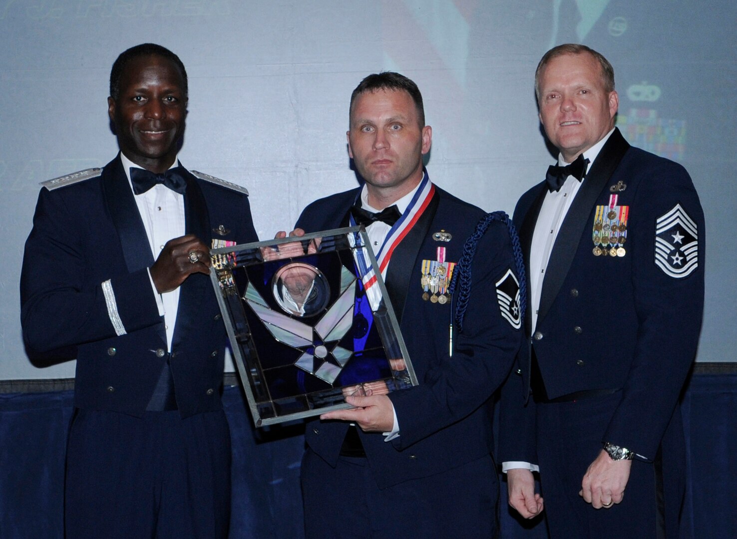 General Edward Rice, Air Education And Training Command commander and Chief Master Sergeant James Cody, Air Education and Training Command , command chief presents Air Education and Training Command Military Training Leader Of The Year award to Master Sergeant  Anthony J. Fisher, 81 Training Group, Kessler Air Force base Mississippi.  Ceremony was held at the Parr Officer Club at Randolph Air Force Base, Texas on March 18.(U.S. Air Force photo/by Don Lindsey).