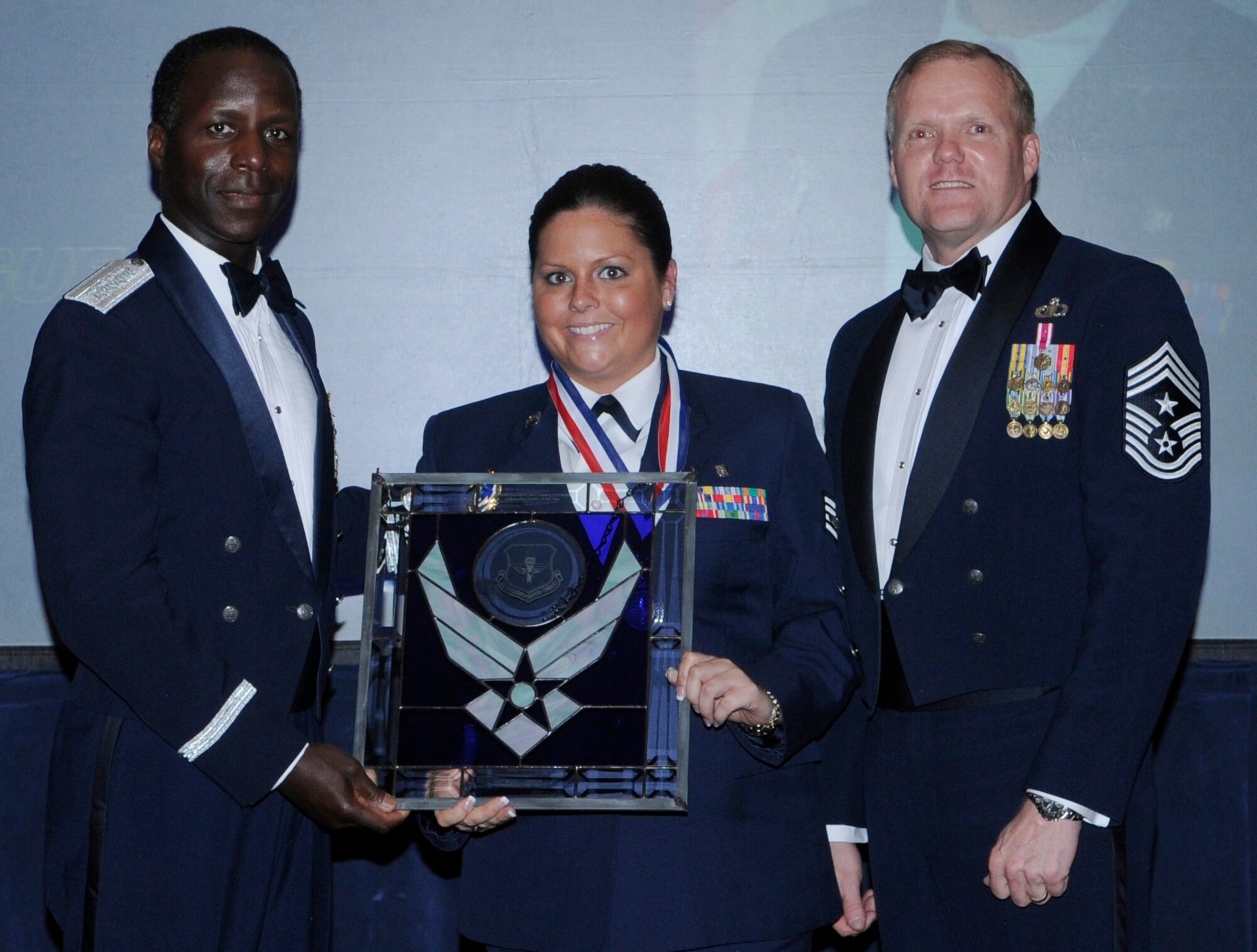 General Edward Rice, Air Education And Training Command commander and Chief Master Sergeant James Cody, Air Education and Training Command , command chief presents Air Education and Training Command Recruiter Of The Year award to Staff Sergeant Megan L Stanton, 313 Recruiting Squadron, Patchogue, New York.  Ceremony was held at the Parr Officer Club at Randolph Air Force Base, Texas on March 18.(U.S. Air Force photo/by Don Lindsey).