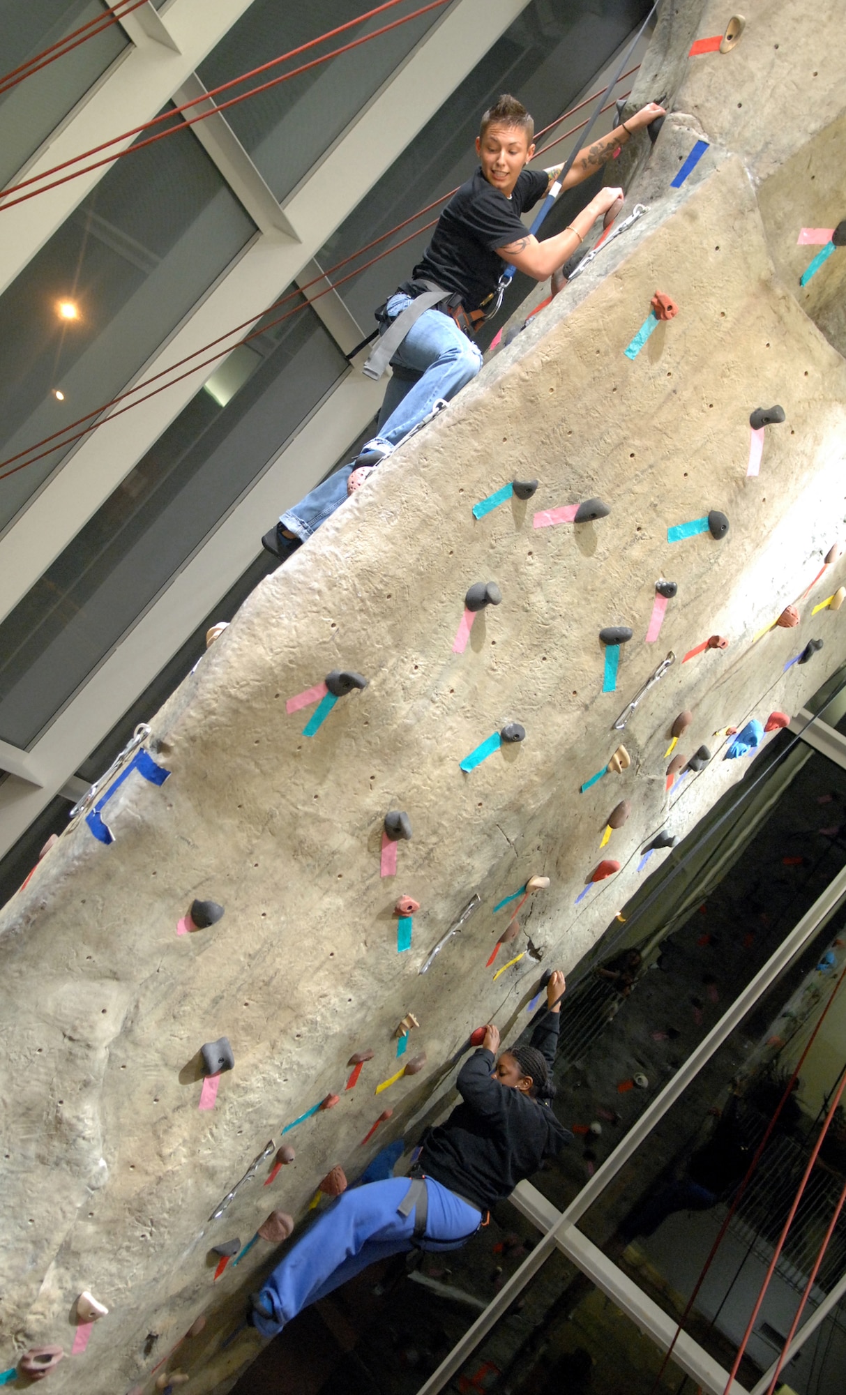 WARRENSBURG, Mo. -- Katherine Althoff and Yulonda Murphy, Airmen from the 509th Communications Squadron, climb the rock wall at the University of Central Missouri's Recreation Center March 18. UCM fun night was sponsored by UCM and Whiteman Air Force Base. (U.S. Air Force photo by Airman 1st Class Cody H. Ramirez)
