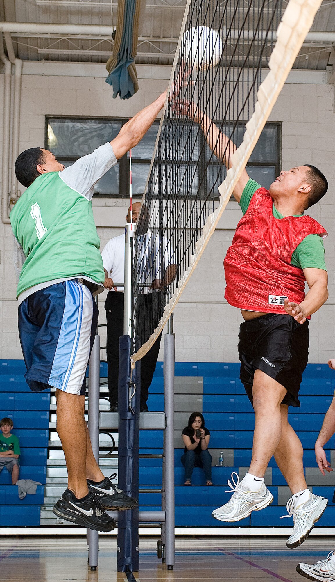 Staff Sgt. Cory Gabourel (left), 736th Aircraft Maintenance Squadron, and Tech. Sgt. Ron Navarro, 436th Maintenance Operations Squadron, face off at the net at the Dover Air Force Base, Del. Fitness Center March 17, 2011. Both teams came into the game 1-0, but the 736th AMXS was the only team to leave with two wins on the season.  (U.S. Air Force photo by Jason Minto)