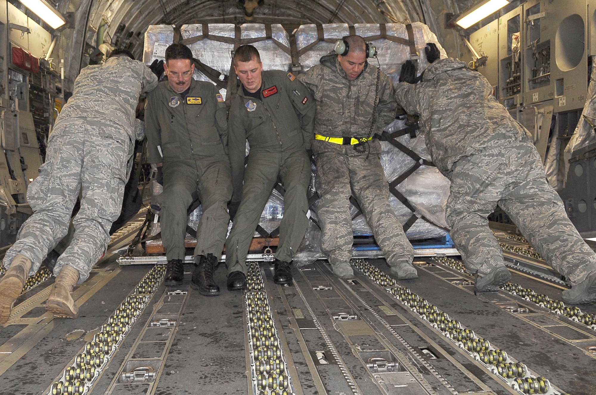 Airmen load a pallet of water onto a C-17 Globemaster III March 21, 2011, at Yokota Air Base, Japan. Crews unloaded the water and other relief items at Sendai Airport as American forces worked with their Japanese counterparts to aid the people of Japan in the aftermath of an earthquake that hit Japan March 11. "Tomodachi" is a Japanese word meaning friends.(U.S. Air Force photo by/Master Sgt. Jeromy K. Cross)
