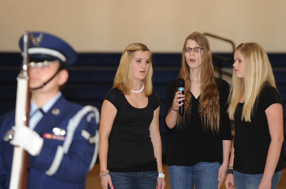 BUCKLEY AIR FORCE BASE, Colo.-- Kristin Beutel (Left), Rebekah Owings (Center), and Alexis Wall (Right), sing the National Anthem at the Youth Basketball game held at the Buckley Fitness Center March 11, 2011. The Buckley Color guard posted the colors while the National Anthem was sung.  (U.S. Air Force photo by Airman Manisha Vasquez)