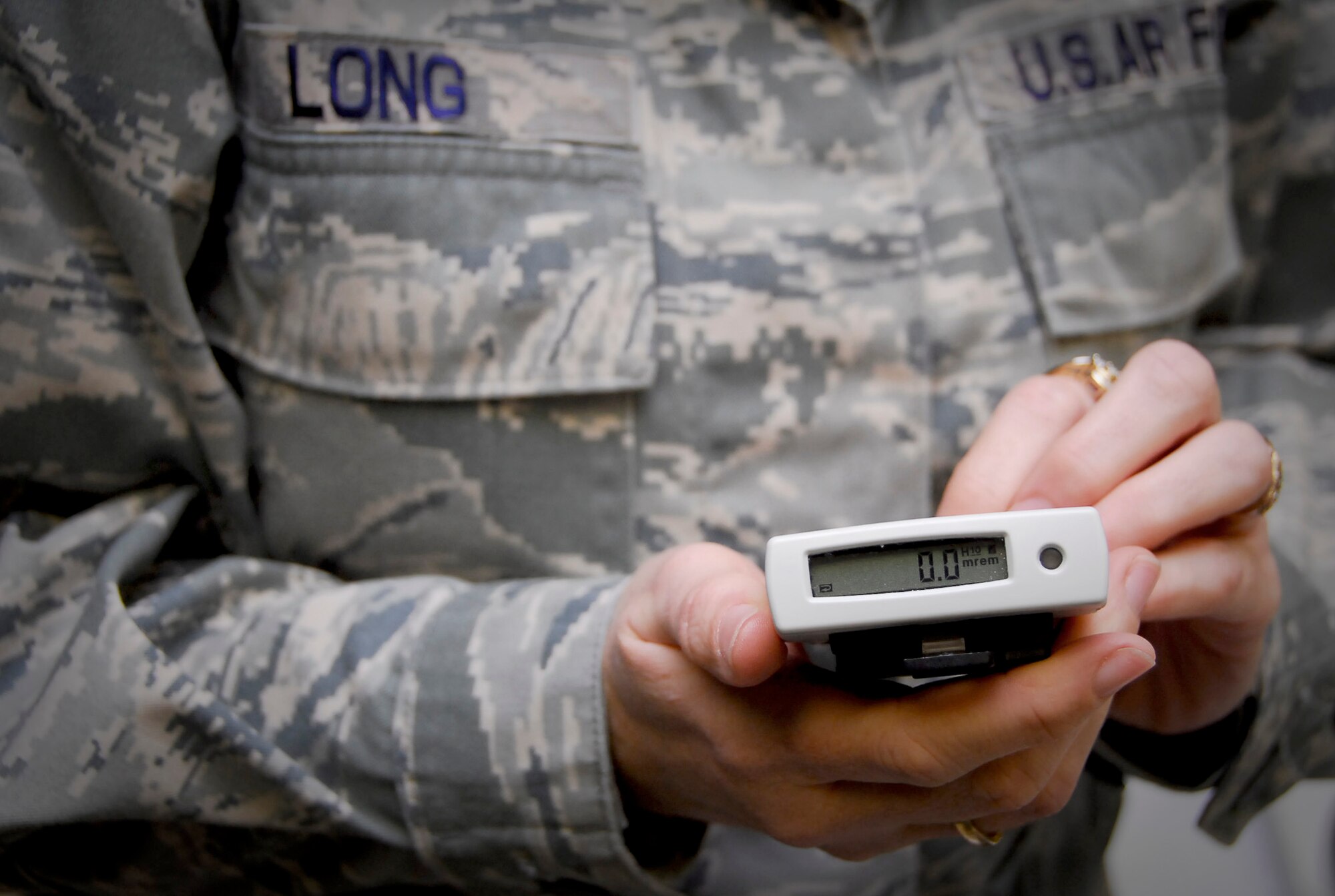 Tech. Sgt. Joanie Long holds an electronic personal dosimeter March 15, 2011, at Kadena Air Base, Japan. The dosimeter is one of the many pieces of equipment Airmen from the 18th Aeromedicine Squadron took to mainland Japan in support of disaster relief efforts. Sergeant Long is the readiness NCO in charge at the 18th AMDS Bioenvironmental Engineering Flight. (U.S. Air Force photo/Airman 1st Class Maeson L. Elleman) 