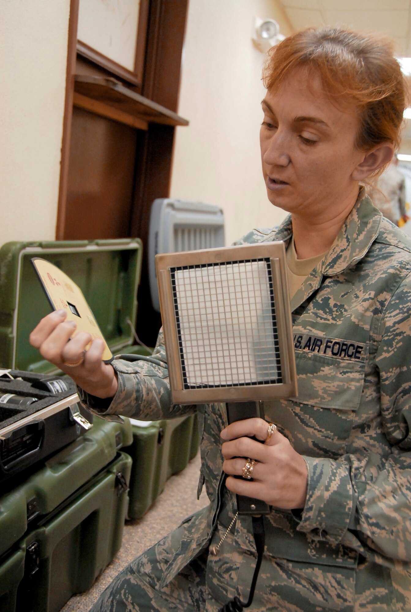 Tech. Sgt. Joanie Long inspects equipment March 15, 2011, at Kadena Air Base, Japan. A team from the 18th Aerospace Medicine Squadron Bioenvironmental Engineering Flight took the equipment to test for radioactive and other harmful chemicals and materials. Sergeant Long is the readiness NCO in charge at the 18th AMDS Bioenvironmental Engineering Flight.(U.S. Air Force photo/Airman 1st Class Maeson L. Elleman)