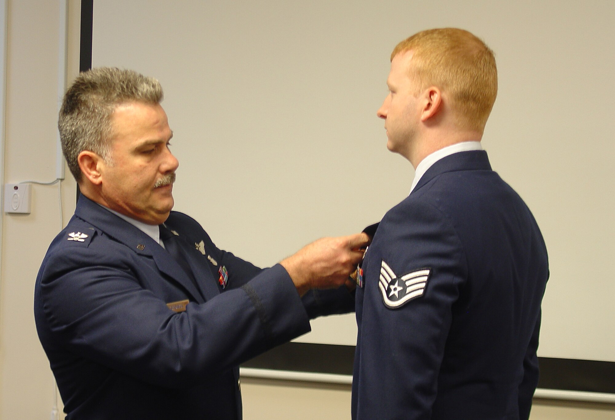 WRIGHT-PATTERSON AIR FORCE BASE, Ohio - Col. Akram Sadaka, 445th Aeromedical Evacuation Squadron commander, pins the Air Force Achievement Medal on Staff Sgt. Paul Mohney during the 445th ASTS commander’s call March 20. (U.S. Air Force photo/Maj. Mary Reed)  