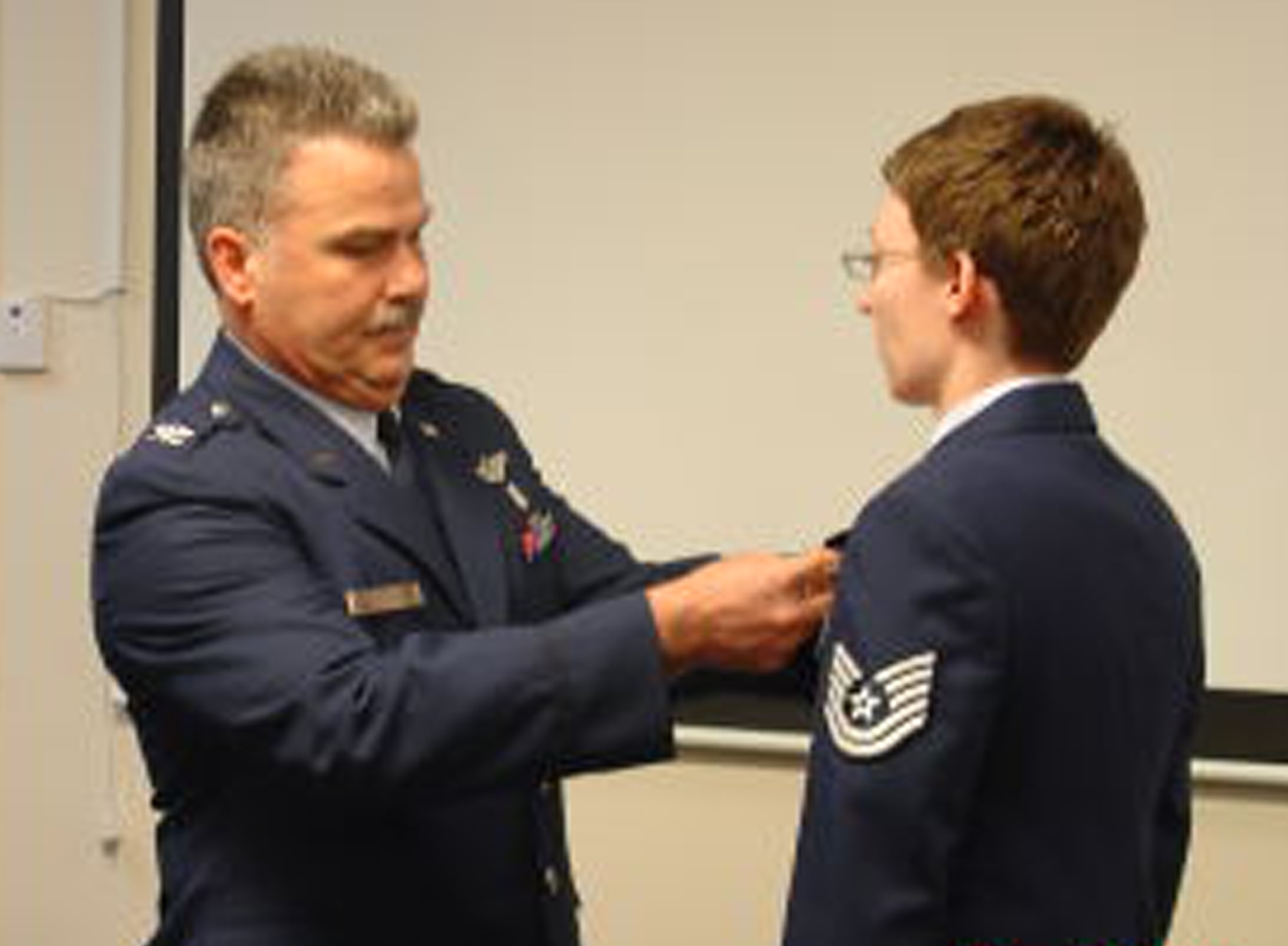WRIGHT-PATTERSON AIR FORCE BASE, Ohio - Col. Akram Sadaka, 445th Aeromedical Evacuation Squadron commander, pins the Air Force Commendation Medal on Tech. Sgt. Angela Robertson during the 445th ASTS commander’s call March 20. (U.S. Air Force photo/Maj. Mary Reed)  