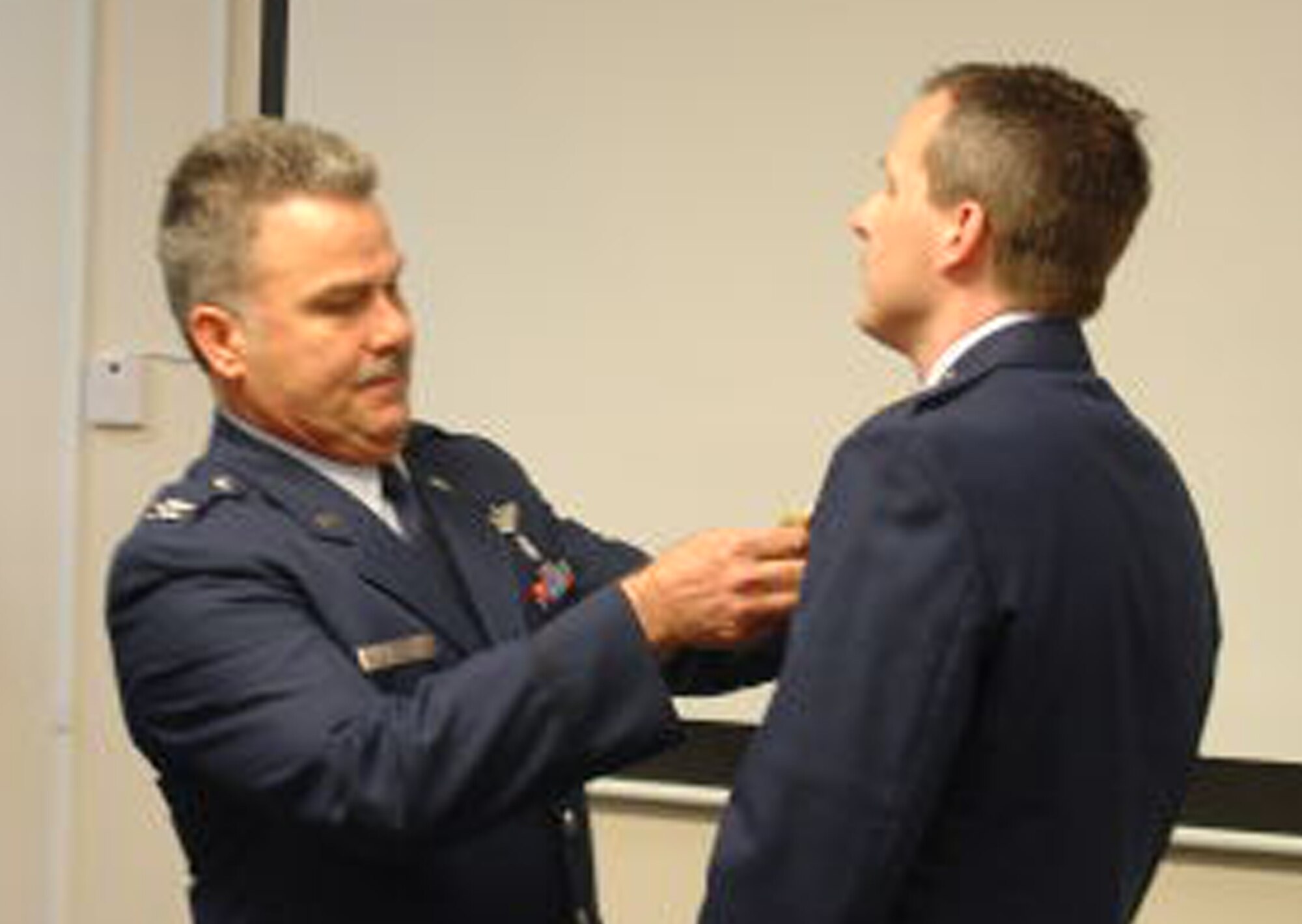 WRIGHT-PATTERSON AIR FORCE BASE, Ohio – Col. Akram Sadaka, 445th Aeromedical Evacuation Squadron commander, pins the Air Force Achievement Medal on Maj. Corey Gallus during the 445th ASTS commander’s call March 20. (U.S. Air Force photo/Maj. Mary Reed)  