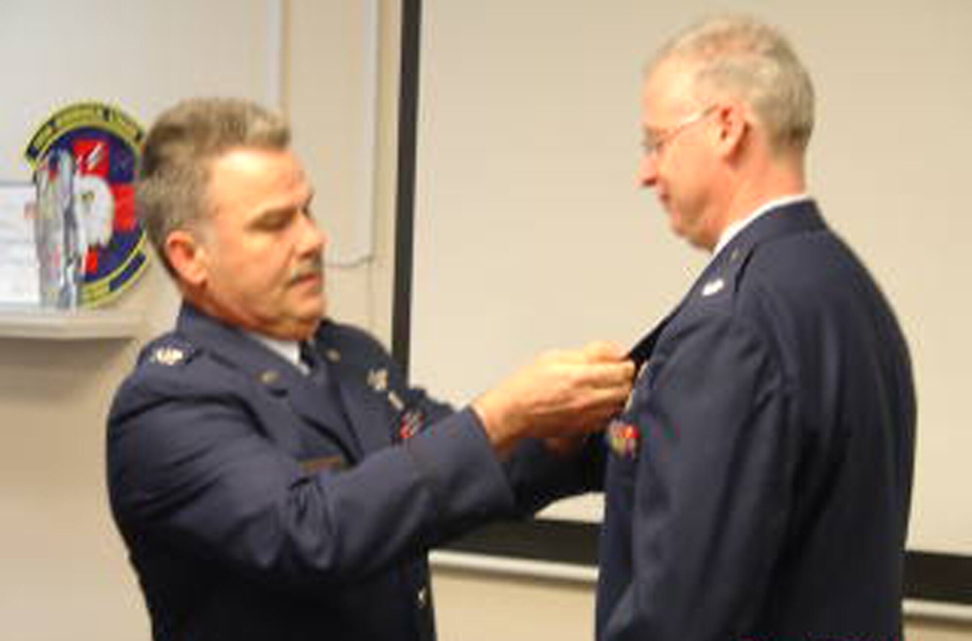 WRIGHT-PATTERSON AIR FORCE BASE, Ohio – Col. Akram Sadaka, 445th Aeromedical Evacuation Squadron commander, pins the Meritorious Service Medal on Lt. Col. Brad Goldman during the 445th ASTS commander’s call March 20. (U.S. Air Force photo/Maj. Mary Reed)  
