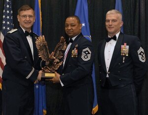 Maj. Gen. Stephen Hoog, Ninth Air Force commander, and Chief Master Sgt. Robert Brooks, 9 AF command chief, present Senior Master Sgt. John Rogers, 633d Security Forces Squadron first sergeant, with the First Sergeant of the Year award during the 2010 9 AF Outstanding Performer of the Year Awards Banquet at the James H. Rainwater Conference Center in Valdosta, Ga., March 10, 2011. Sergeant Rogers is the second consecutive Squadron shirt to win the 9 AF-level award. (Photo courtesy/Senior Master Sgt. John Rogers/RELEASED)