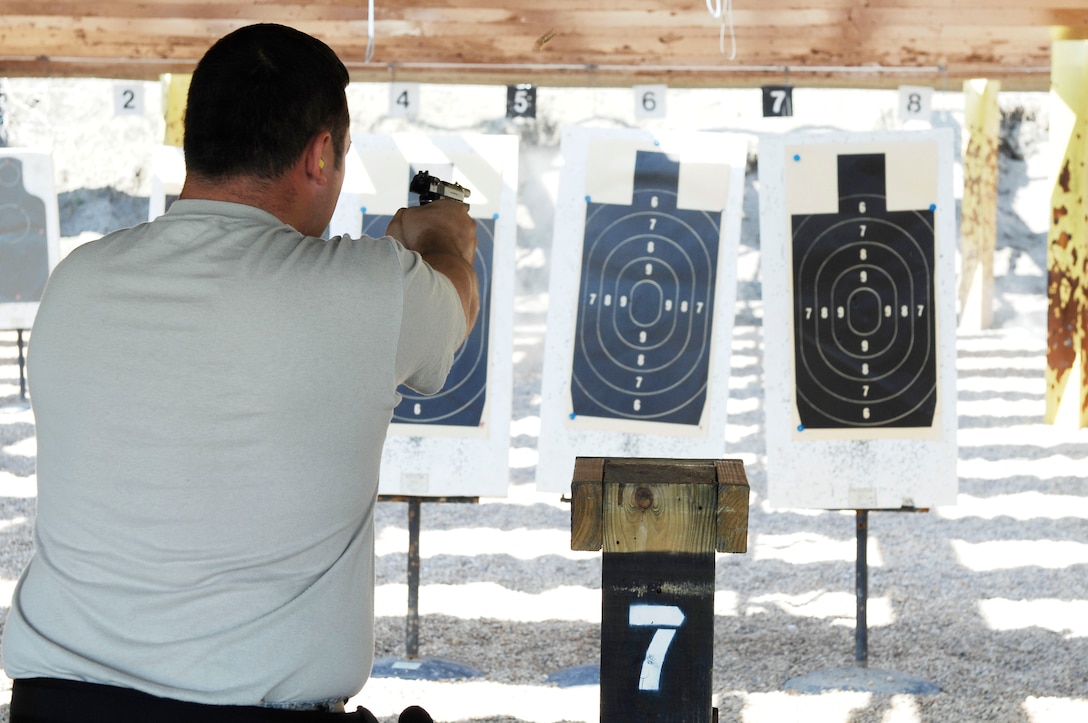 Staff Sgt. Chris Rocchio, 633d Security Forces squadron military working dog section, fires his weapon at a target during a marksmanship competition at Langley Air Force Base, Va., March 18, 2011. Security forces members participated in the first annual event, to build unit morale and create cohesiveness between the Joint Base Langley-Eustis military police squadrons. (U.S. Air Force photo by Airman 1st Class Kayla Newman/Released)