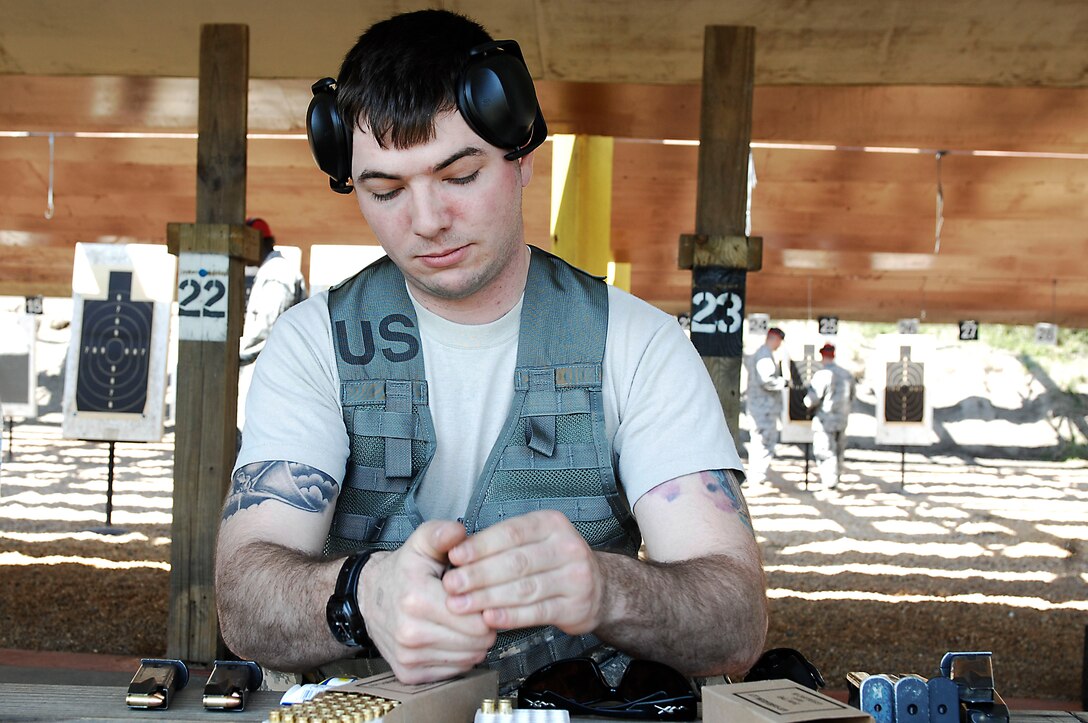 Staff Sgt. Dustin Sweeney, 633d Security Forces squadron desk sergeant, loads bullets into a magazine during a marksmanship competition at Langley Air Force Base, Va., March 18, 2011. Security forces members participated in the first annual event to build cohesiveness between Joint Base Langley-Eustis military police. (U.S. Air Force photo by Airman 1st Class Kayla Newman/Released)