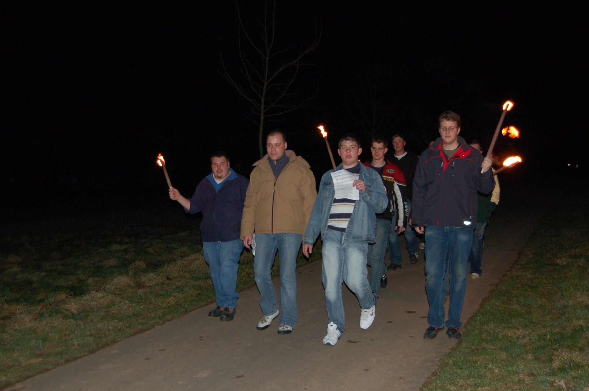 PREISTS, Germany-- A group of young people from Preist, a community located outside of Spangdahlem, arrive at the bonfire area with torch lights. This group was responsible for lighting the big bonfire. The old tradition of lighting bonfires has been carried on by the people of the Eifel for many generations. It signifies the end of winter.  (U.S. Air Force Photo/Iris Reiff)
