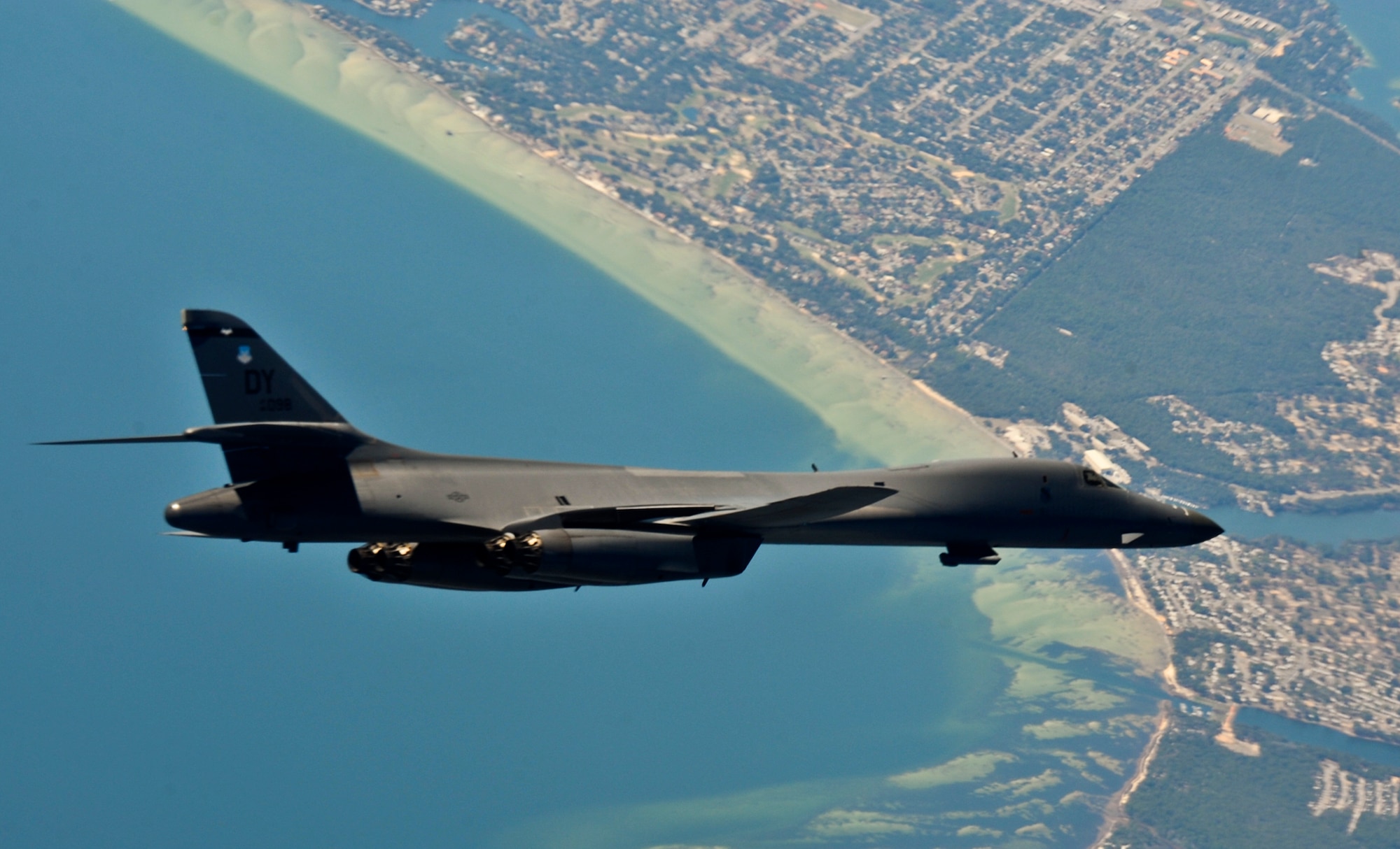 A B-1B Lancer soars over the Gulf Coast during a Combat Hammer Sortie on the Eglin Air Force Base range March 16.  The bomber from the 7th Bomb Wing at Dyess AFB, Texas, flew in and dropped a Guided Bomb Unit-32 during the week-long air-to-ground weapons system evaluation program known as Combat Hammer. The 86th Fighter Weapons Squadron hosts 20 to 25 evaluations at Hill and Eglin each year, assessing weapon system performance, reliability, capabilities, and limitations in realistic combat scenarios against representative real-world targets.  (Courtesy photo.)