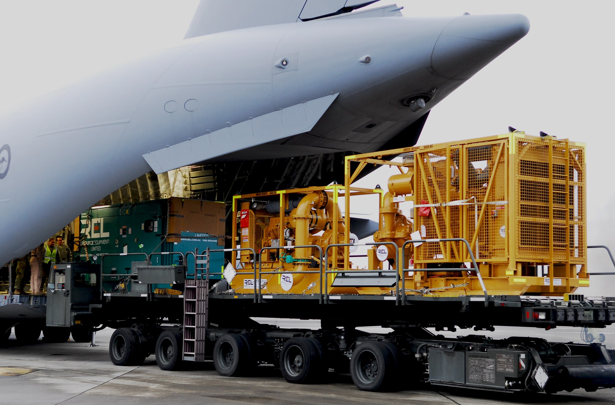 YOKOTA AIR BASE, Japan -- A water cannon system transported to Yokota by a Royal Australian Air Force C-17 Globemaster III is downloaded from the aircraft here March 22. (U.S. Air Force photo/Staff Sgt. Robin Stanchak)