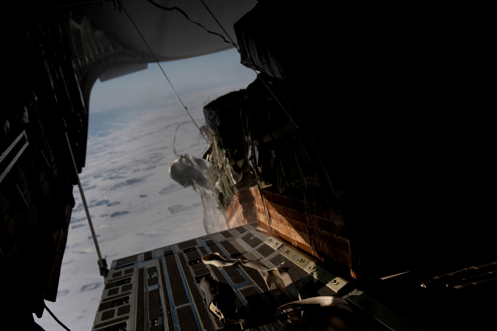 Air delivery cargo from an 816th Expeditionary Airlift Squadron C-17 Globemaster III is released over the skies of Afghanistan. The C-17 aircrew air delivered the cargo which consisted of fuel and other various supplies to a remote forward operating base in Afghanistan. The aircrew is deployed from the 7th Airlift Squadron, McChord AFB, Wash.