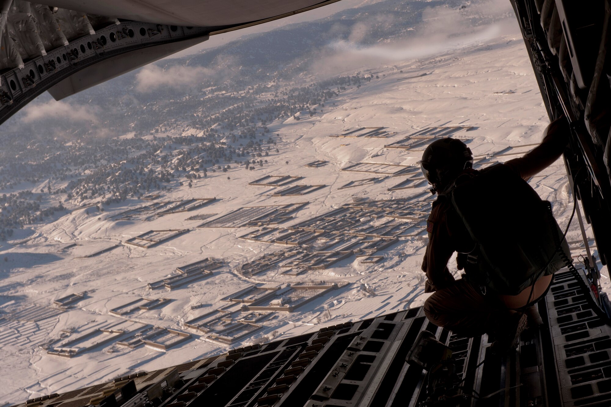 Staff Sgt. Christopher Bankston, 816th Expeditionary Airlift Squadron loadmaster, watches as air delivery cargo from a C-17 Globemaster III is released over the skies of Afghanistan. The C-17 aircrew air delivered the cargo which consisted of fuel and other various supplies to a remote forward operating base in Afghanistan. Sergeant Bankston is deployed from the 7th Airlift Squadron, McChord AFB, Wash.