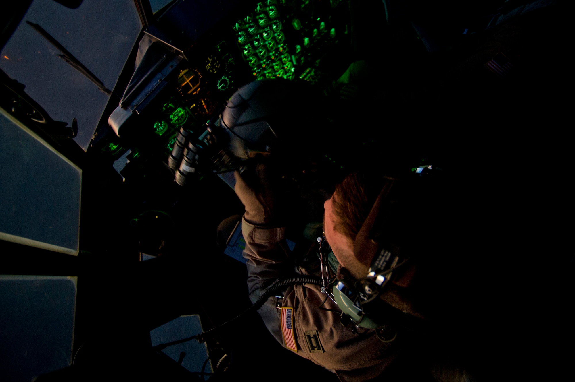 Capt. Richard Konopczynski, 746th Expeditionary Airlift Squadron C-130 Hercules pilot, prepares to put on his helmet and night vision goggles as he flies an air transport mission in support of Operation New Dawn. The C-130 crew transported soldiers from the 4th Infantry Division out of Iraq on the first leg of their return trip home after completing their deployment. Captain Konopczynski is deployed from the 914th Airlift Wing, Niagara Falls, N.Y. 