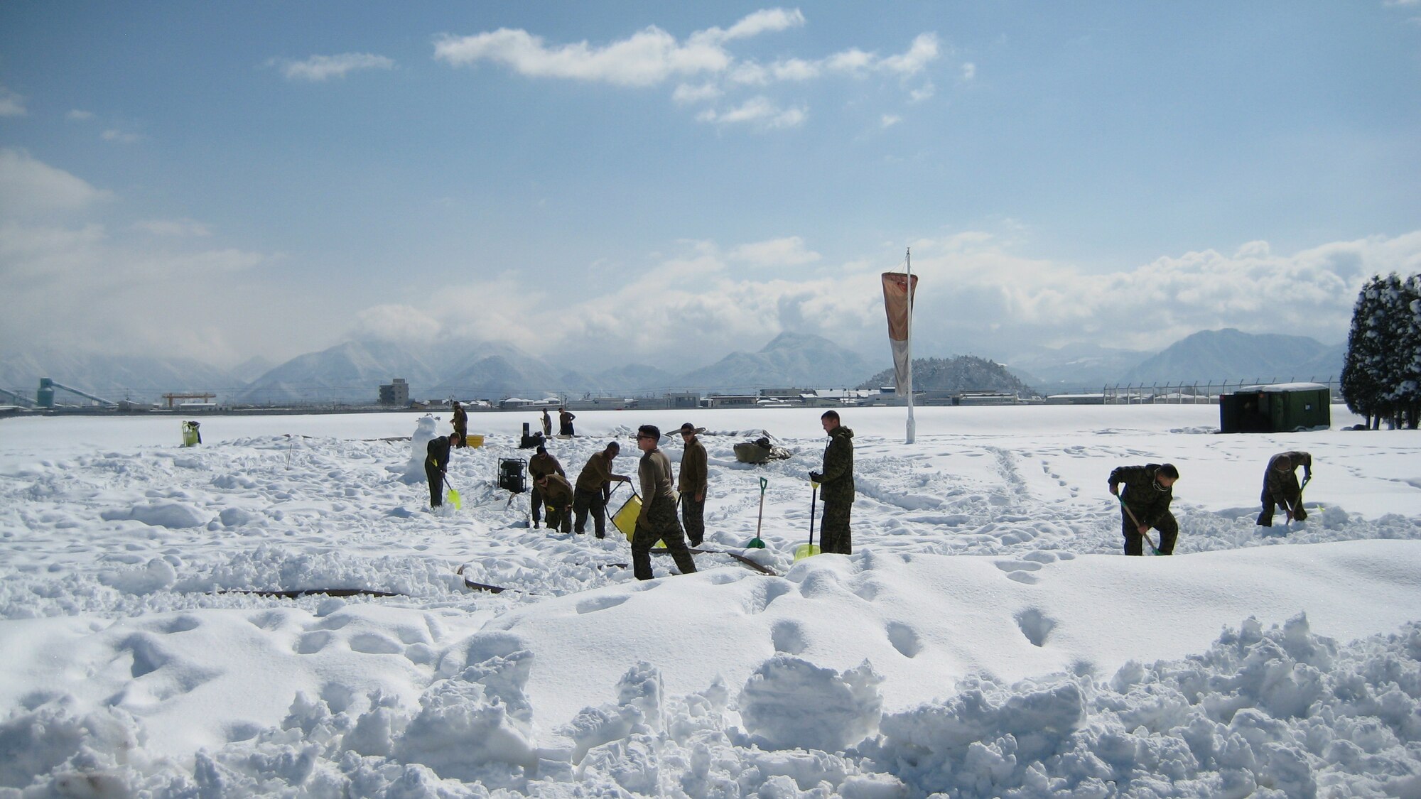YAMAGATA, Japan -- Airmen from the 374th Logistics Readiness Squadron Fuels Management Flight work with Marines at a forward area refueling point in support of humanitarian assistance/disaster relief efforts March 18. A FARP allows aircraft to operate from airfields where fuel is not usually available. The 374th LRS sent four Airmen and an R-11 fuel truck to augment the Marines. (Courtesy photo)