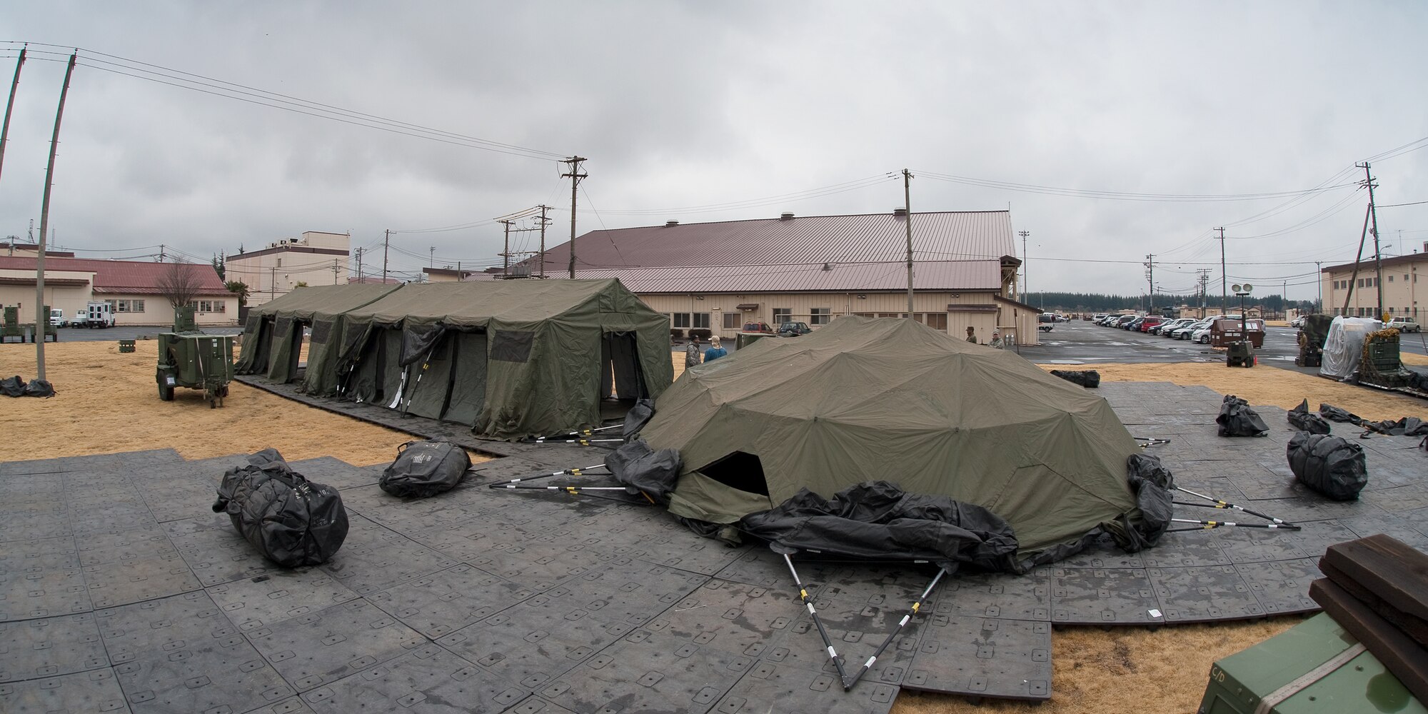 YOKOTA AIR BASE, Japan -- Pacific Command personnel build tents here, March 22. The tents will provide additional workspace for personnel deploying to Yokota in support of Operation Tomodachi. (U.S. Air Force photo/Osakabe Yasuo)