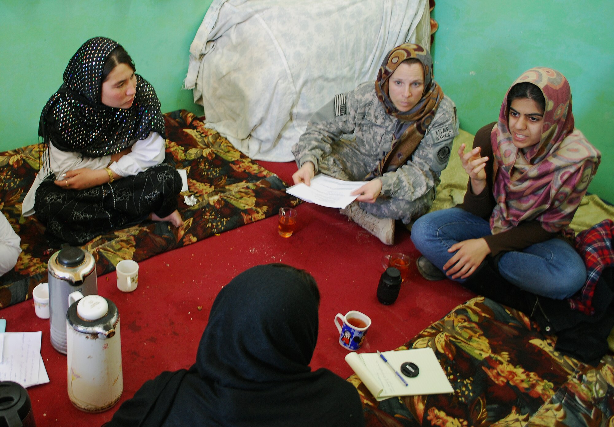 Capt. Dawn Russell, Provincial Reconstruction Team Zabul medic, sits with the midwives during a recent meeting to discuss family planning for the women of Zabul province. (U.S. Air Force photo/Tech. Sgt. Stacia Zachary)