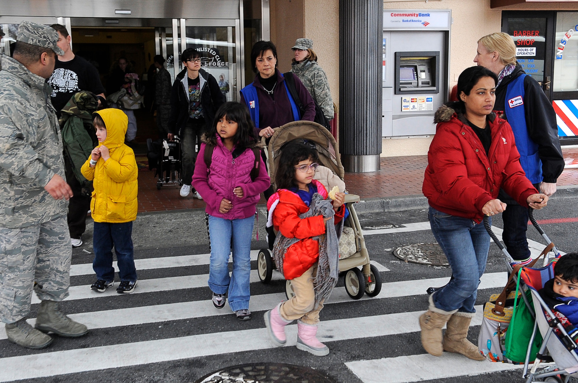 YOKOTA AIR BASE, Japan -- Military families from Fleet Activities Yokosuka, Japan, depart the  Enlisted Club here in preparation to catch a plane to Seattle, Washington March 22, 2011. These and other millitary dependents left as part of a voluntary assisted departure. The Department of State approved the voluntary authorized departure for eligible family members until the situation in Japan has resolved. (U.S. Air Force photo/Master Sgt. Jeromy K. Cross)

