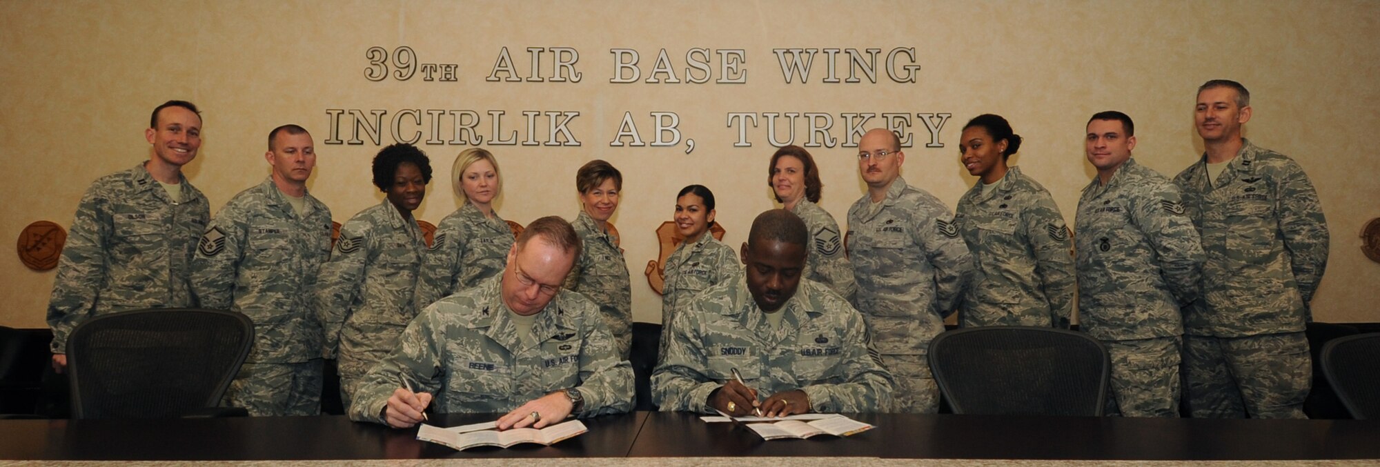 Col. Eric Beene, the 39th Air Base Wing commander, and Chief Master Sgt. Marcus Snoddy, the 39th Air Base Wing command chief, were the first Airmen on base to contribute to the Air Force Assistance Fund, March 15, 2011, at Incirlik Air Base, Turkey. The 2011 campaign is March 28-May 6. (U.S. Air Force photo by Airman 1st Class Clayton Lenhardt/Released)
