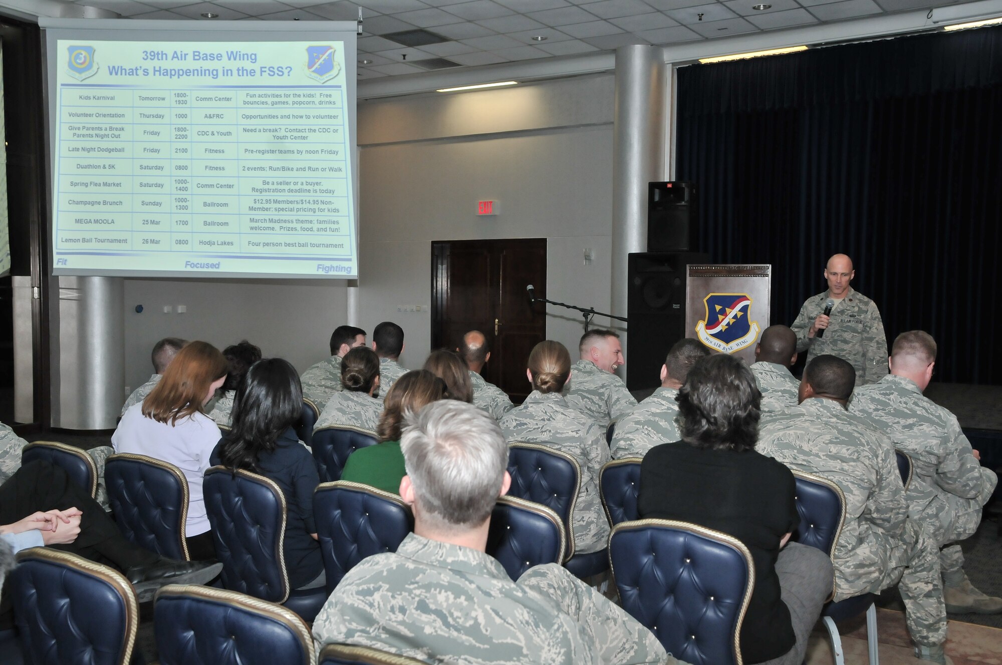 Maj. Tom Ausherman, the 39th Force Support Squadron commander, briefs the Incirlik community on FSS-sponsored events during the 39th Air Base Wing town hall meeting.  Town hall meetings are held quarterly as a way for base leadership to address community concerns and receive feedback.  (U.S. Air Force photo by Staff Sergeant Alex Montes/Released)